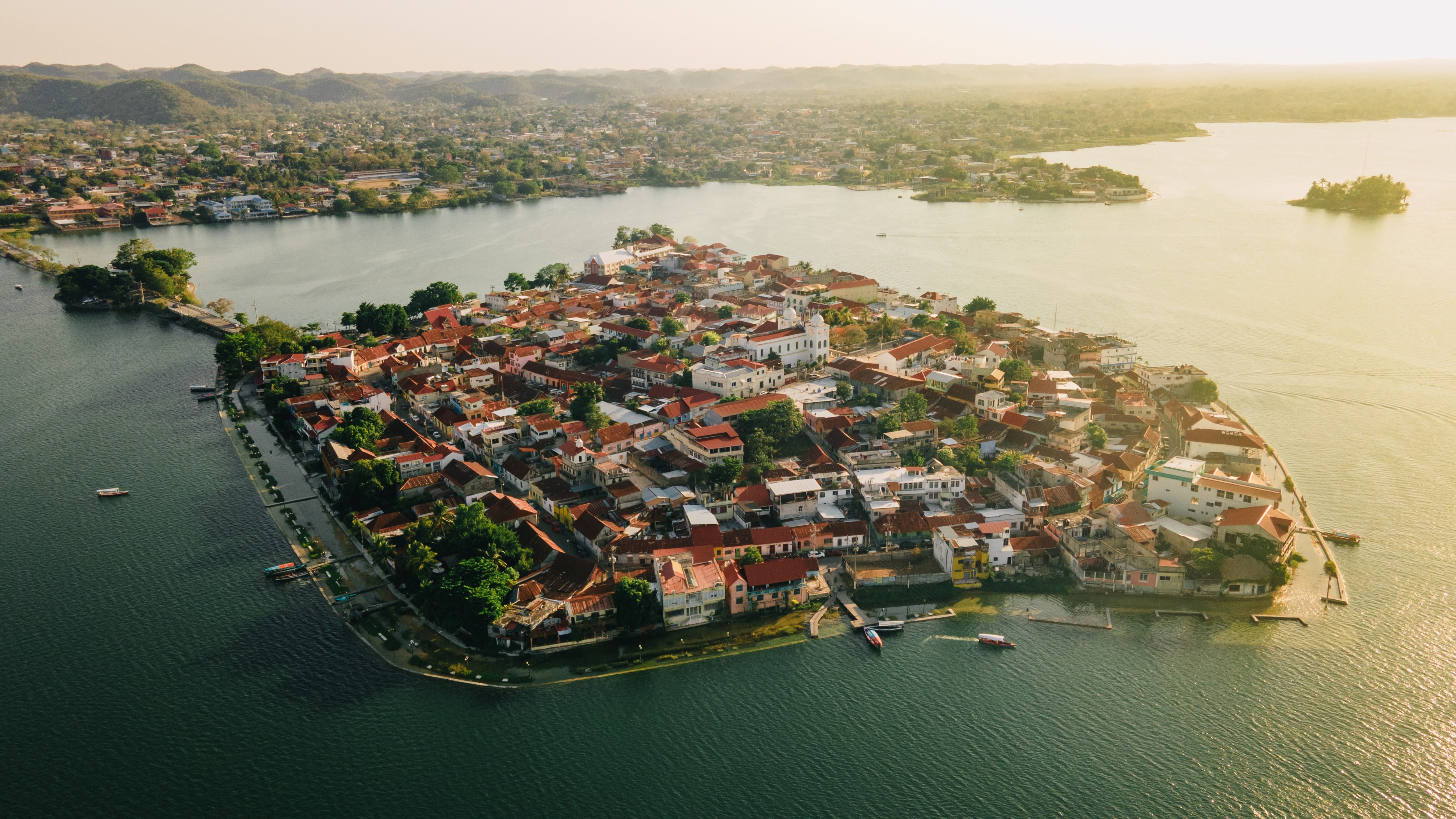Colourful colonial architecture and serene lakeside views on the island town of Flores, a vibrant hub for local gastronomy and culture