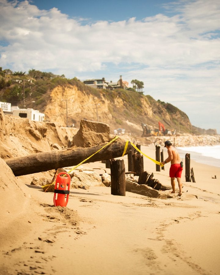 Lifeguards tape up the area where the erosion hit worst