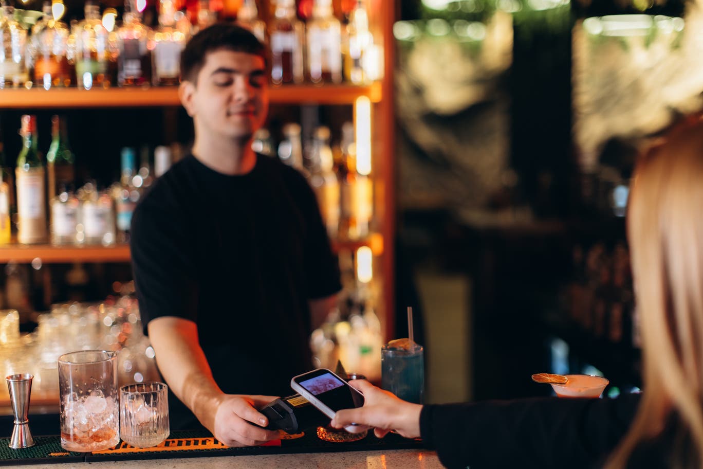 Why are British pubs adding a service charge for pouring a pint?
