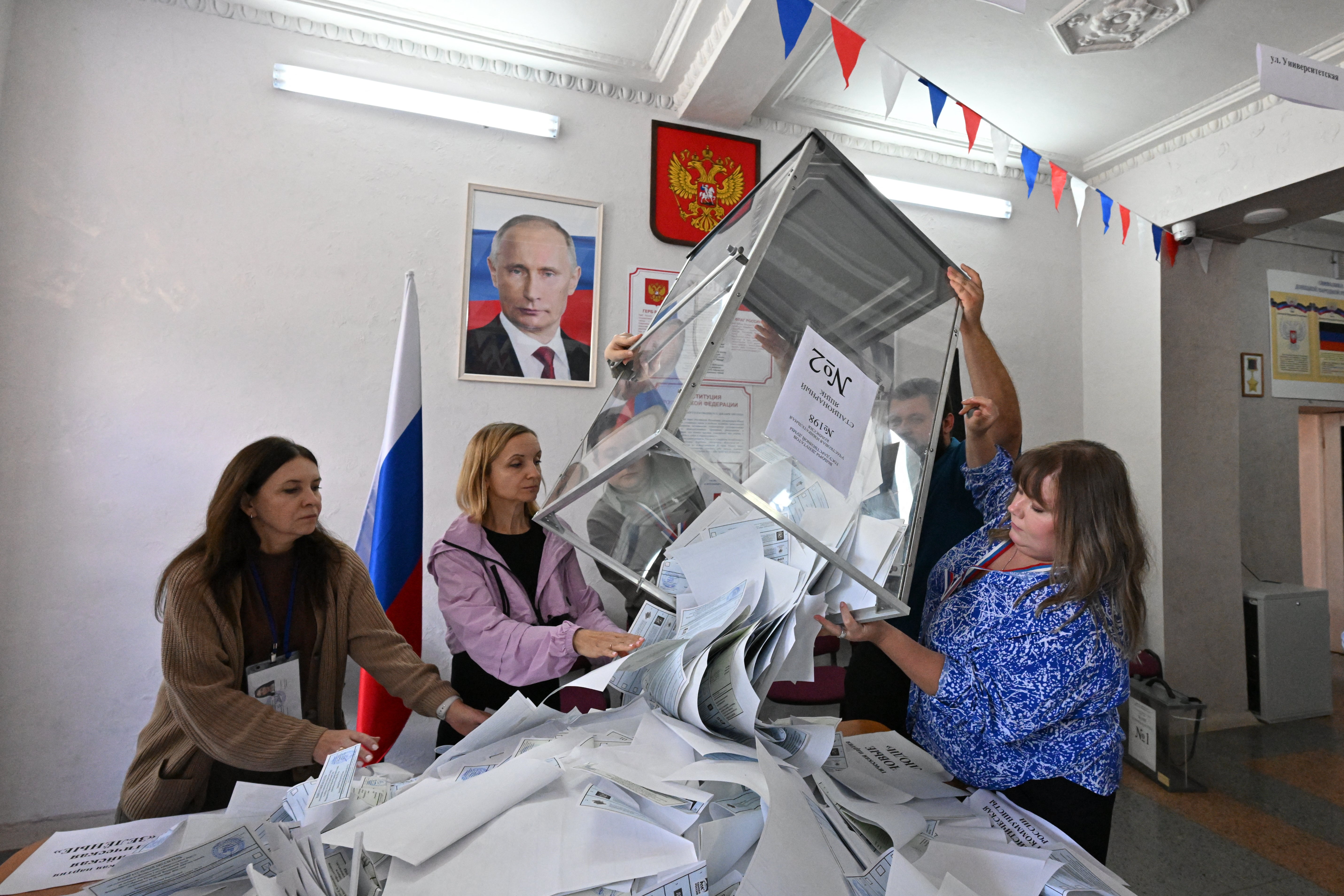 Members of a local electoral commission empty a ballot box to count votes in Russia's parliamentary election in Donetsk, Russian-controlled Ukraine (AFP/Getty)