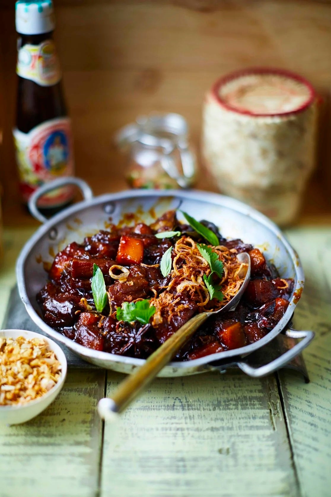 A dark, glossy braise of pork belly and pumpkin, finished with crisp shallots and plenty of fish sauce