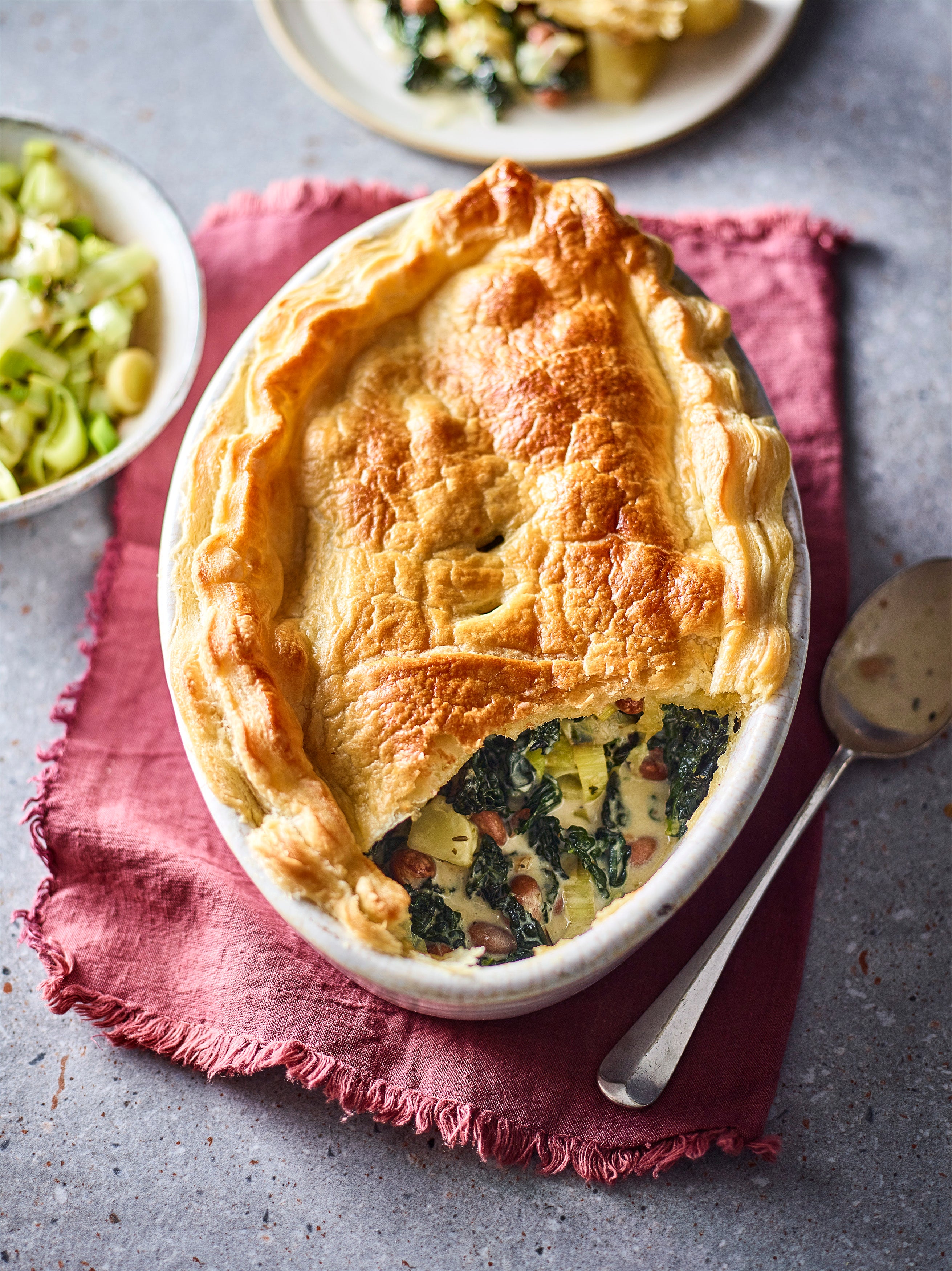 Cavolo nero, borlotti beans and potatoes sit beneath a crisp puff pastry lid in this easy meat-free pie
