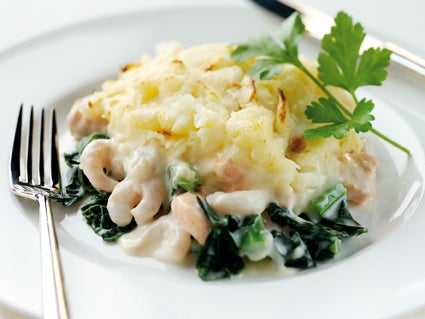 A layer of cavolo nero brings colour and texture to a classic fish pie filled with salmon, cod and prawns