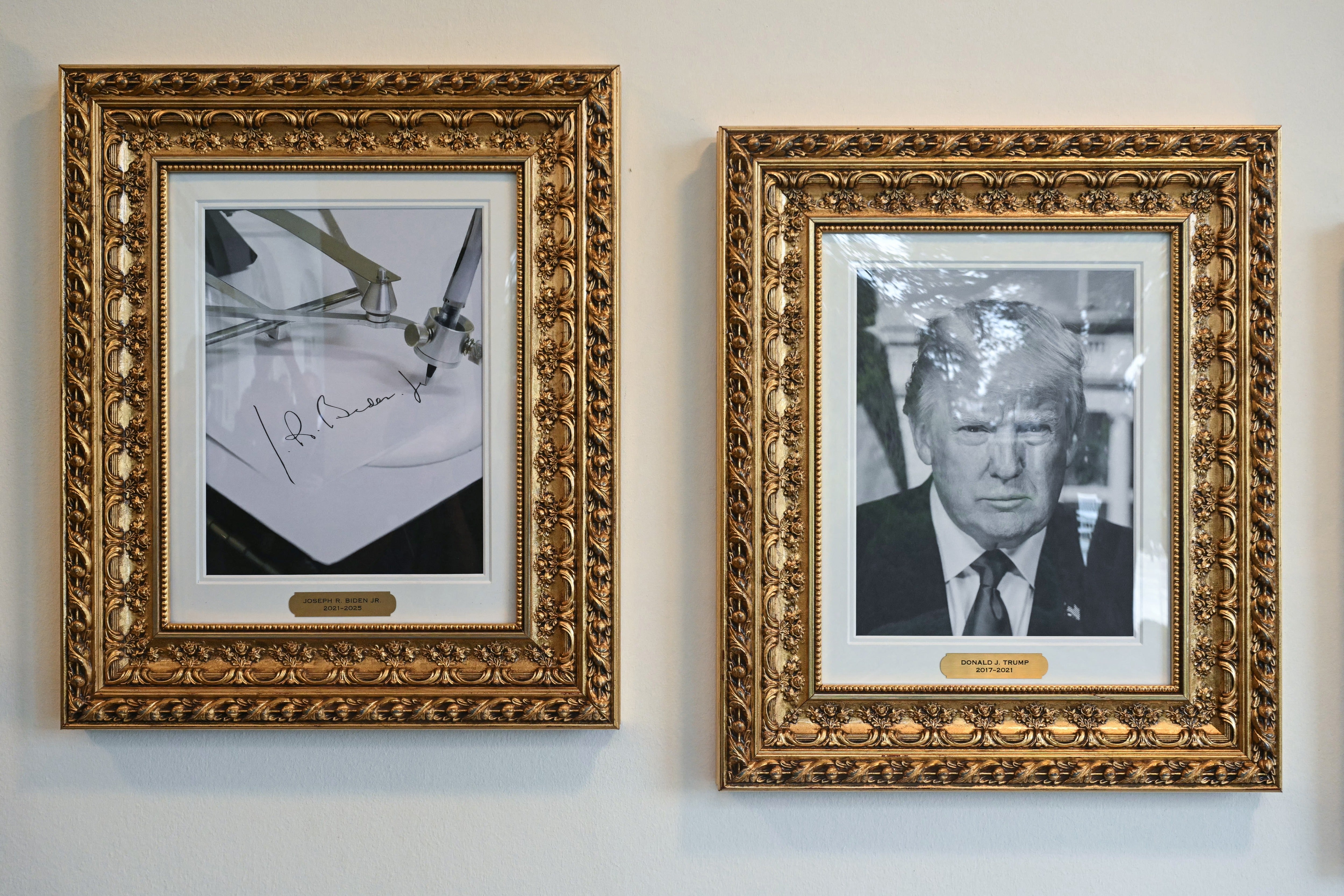 A framed photo of Trump hangs next to a picture of an ‘autopen’ to represent former President Joe Biden on the wall of the colonnade near the Rose Garden of the White House in Washington, DC