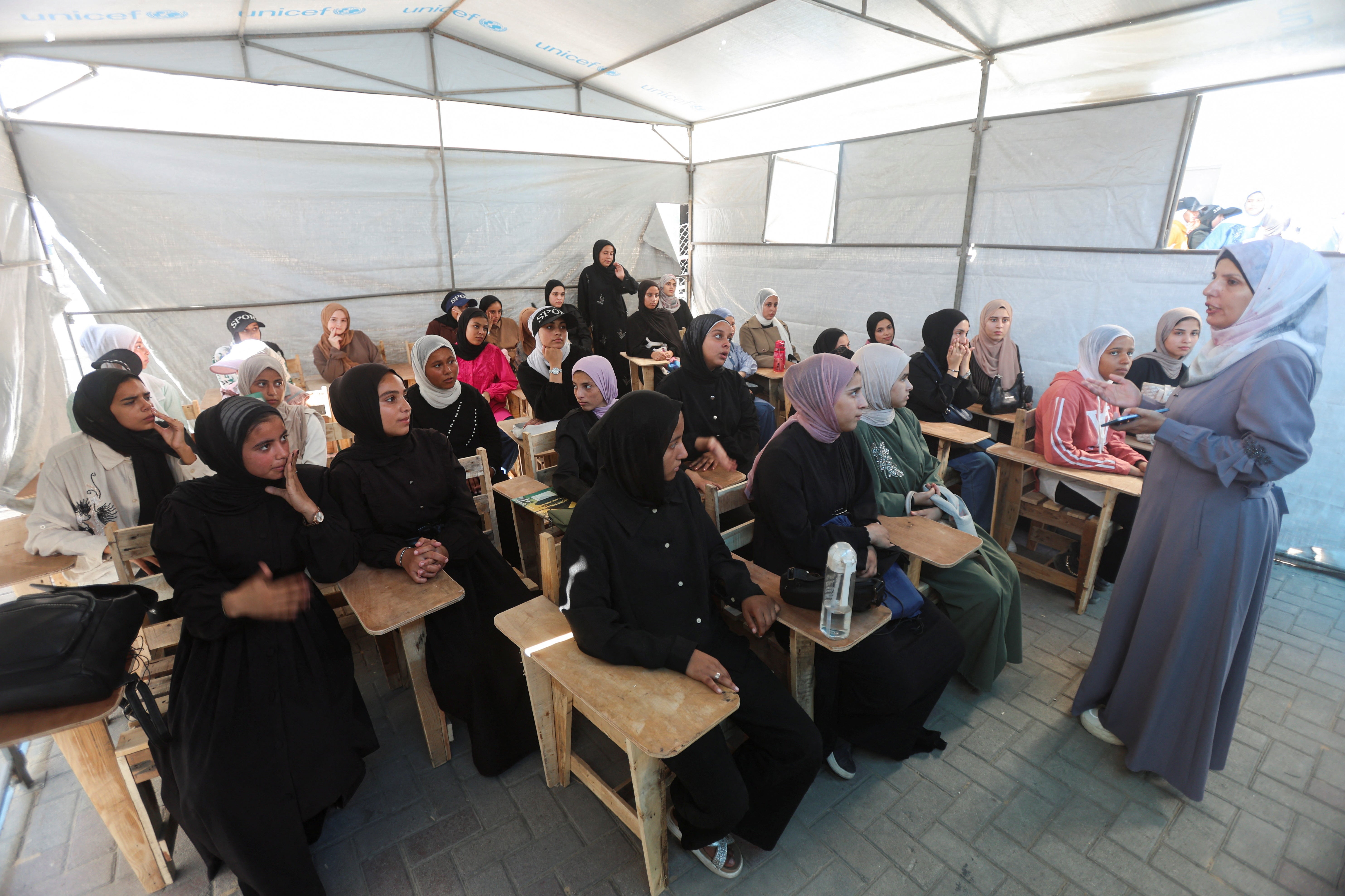 A Palestinian teacher conducts a lesson for displaced Palestinian students, including Samar Abu Salmi, 15, inside a tent classroom in Khan Younis, in the southern Gaza Strip, September 20, 2026