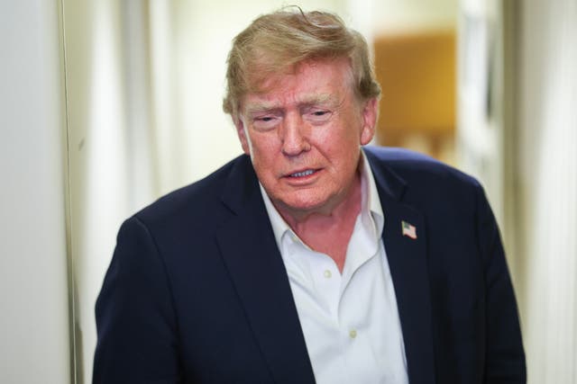 President Donald Trump speaks to reporters aboard Air Force One while traveling back from Ireland to Joint Base Andrews, Maryland