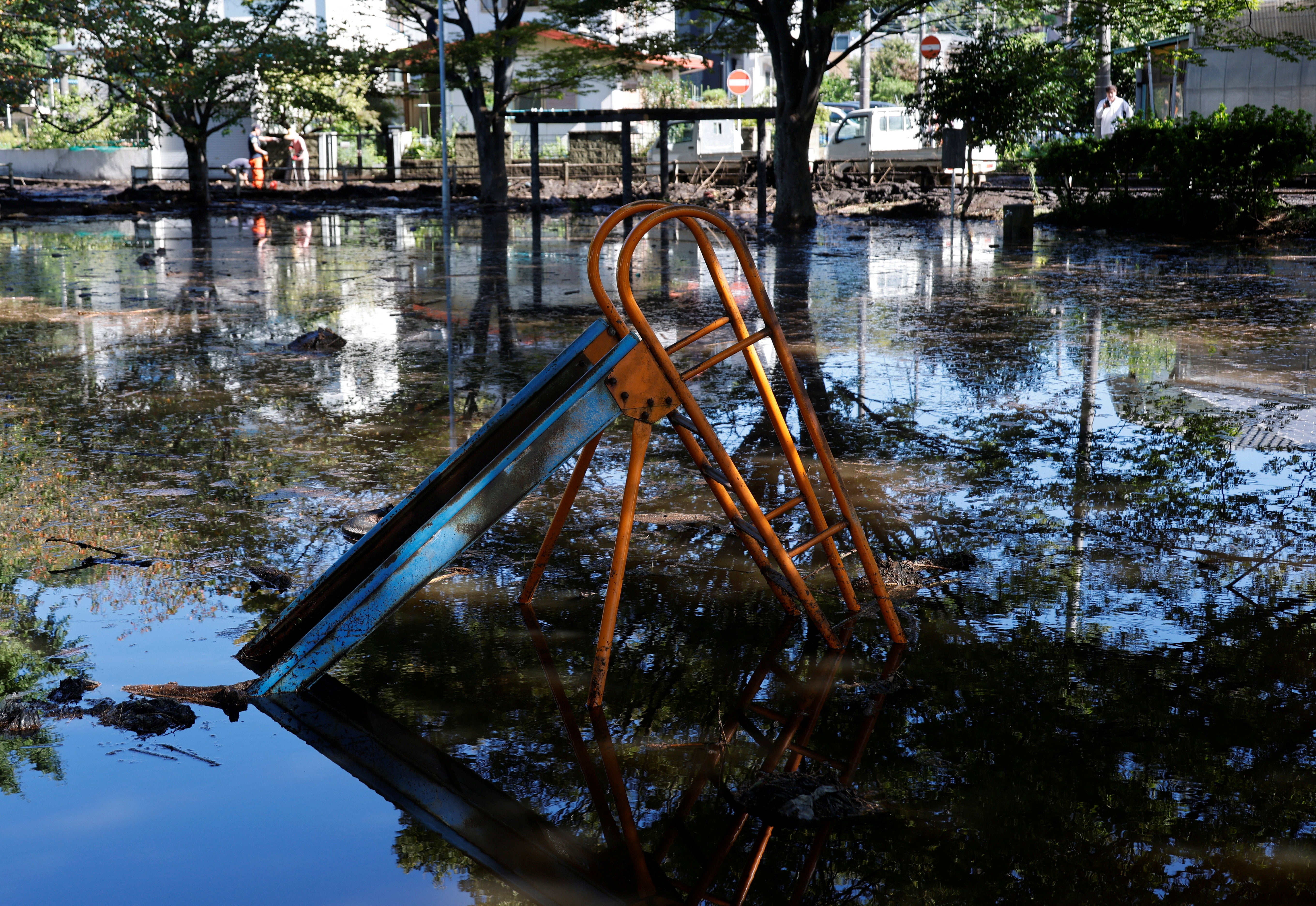 Floodwater covers a children's playground near a house hit by a landslide triggered by Typhoon Dujuan, in Miura on 22 September 2026