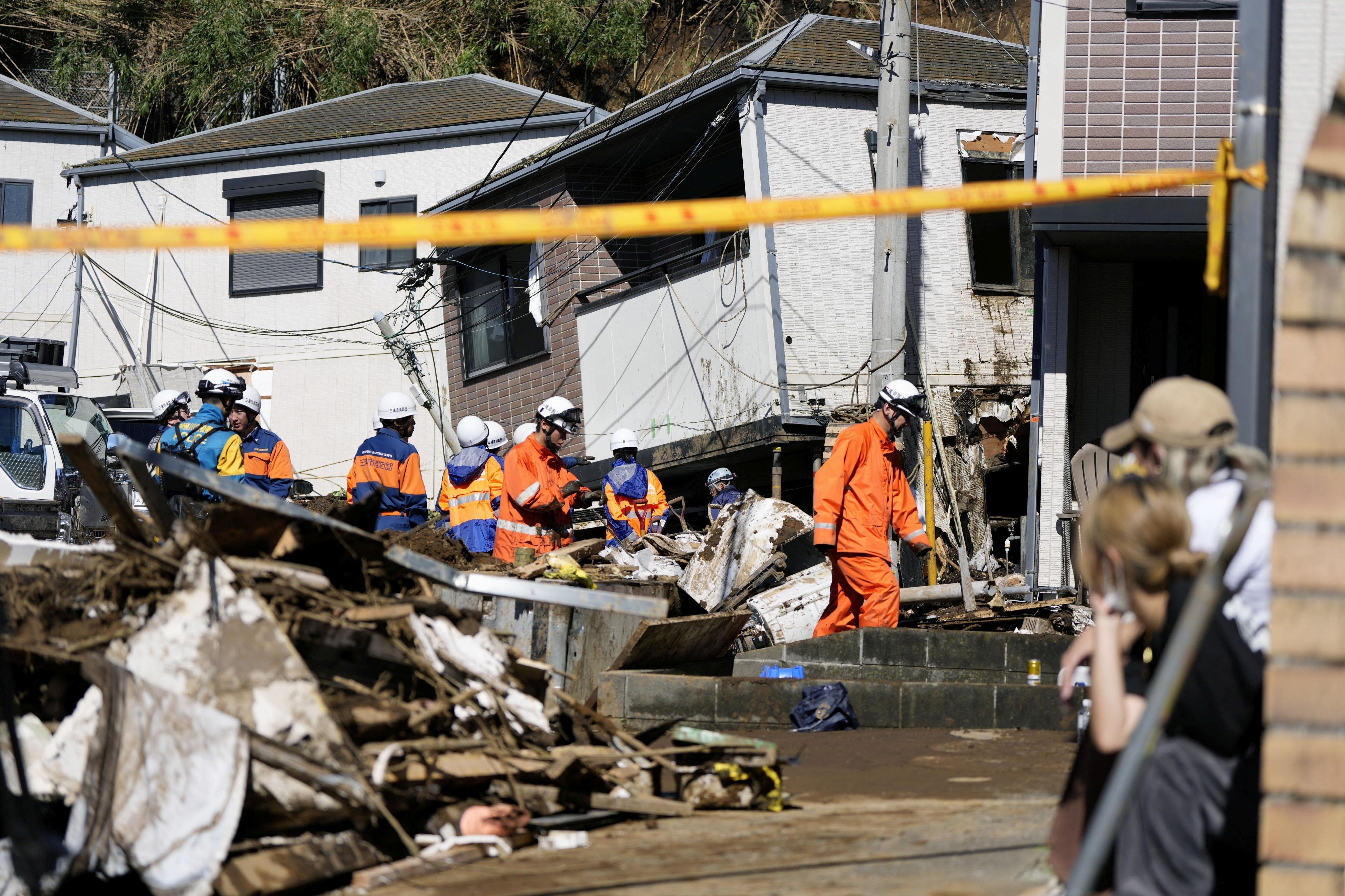 Rescue workers conduct a rescue and search operation for a missing person at a house hit by a landslide triggered by Typhoon Dujuan in Miura, Kanagawa Prefecture, Japan, 22 September 2026, in this photo taken by Kyodo (Reuters)