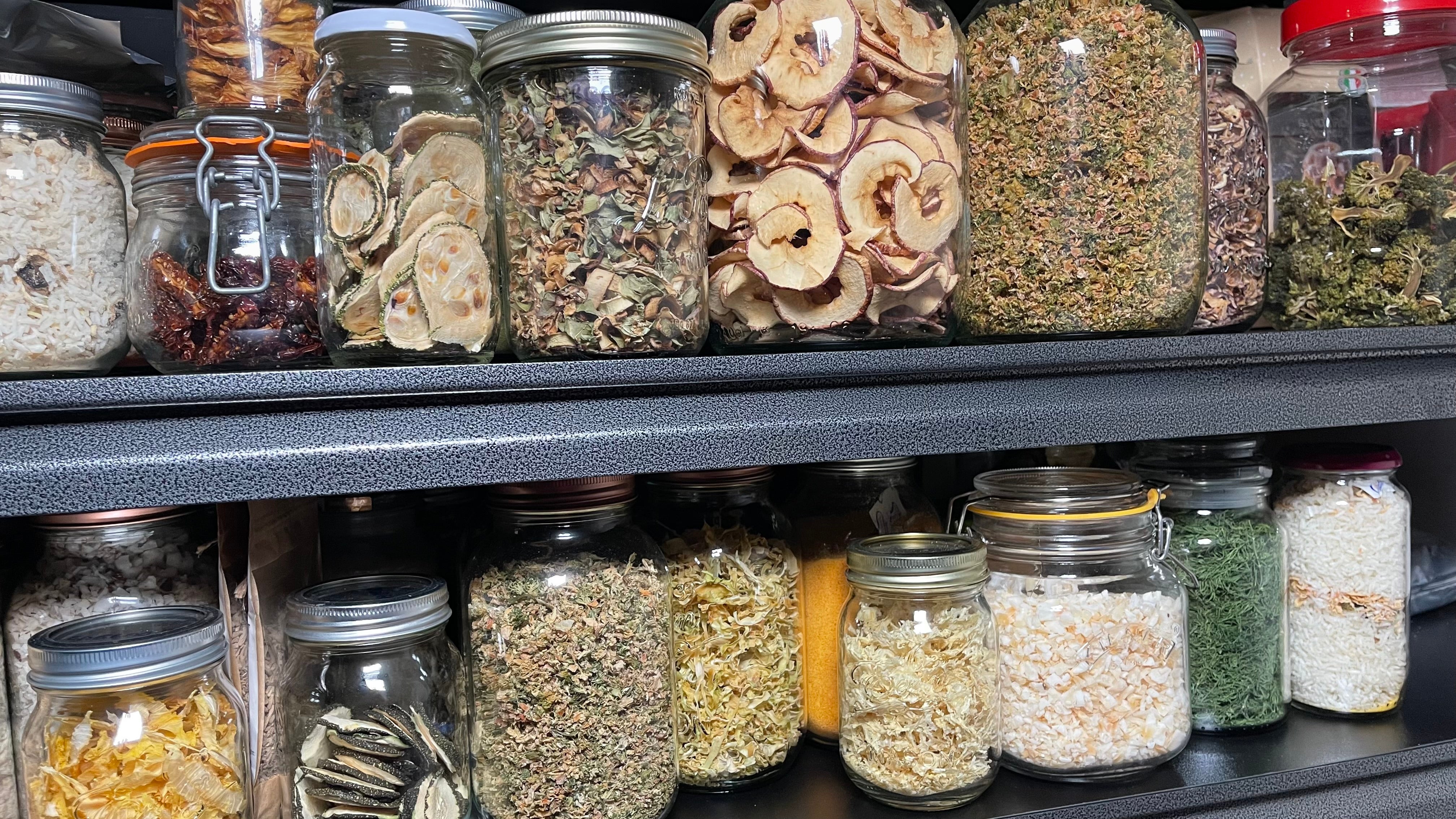 Mushrooms, broccoli and pepper are among the items Ana dries and then stores in glass containers in her home