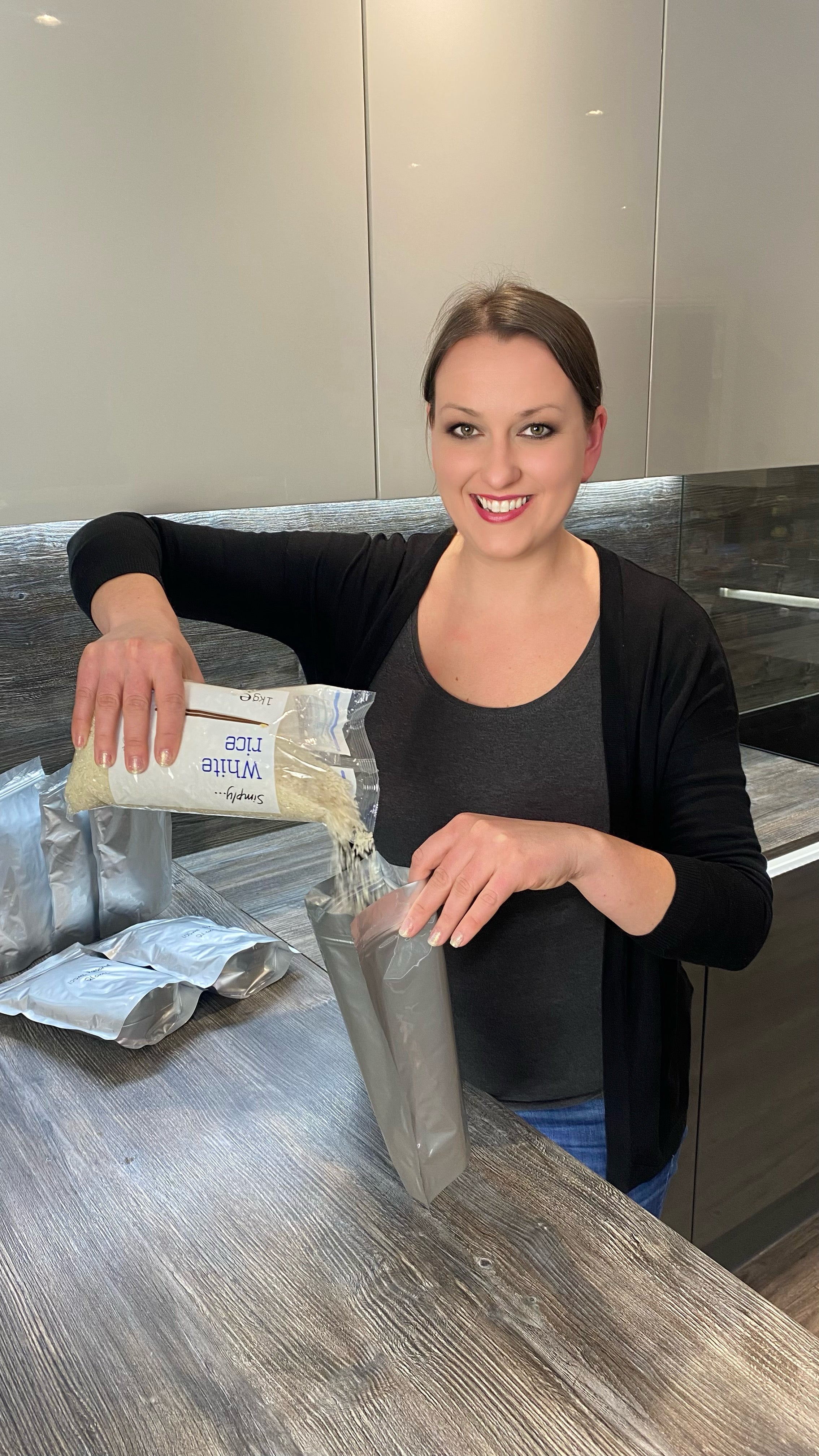 Ana seals white rice in packets for her pantry under her stairs at her home in south Wales
