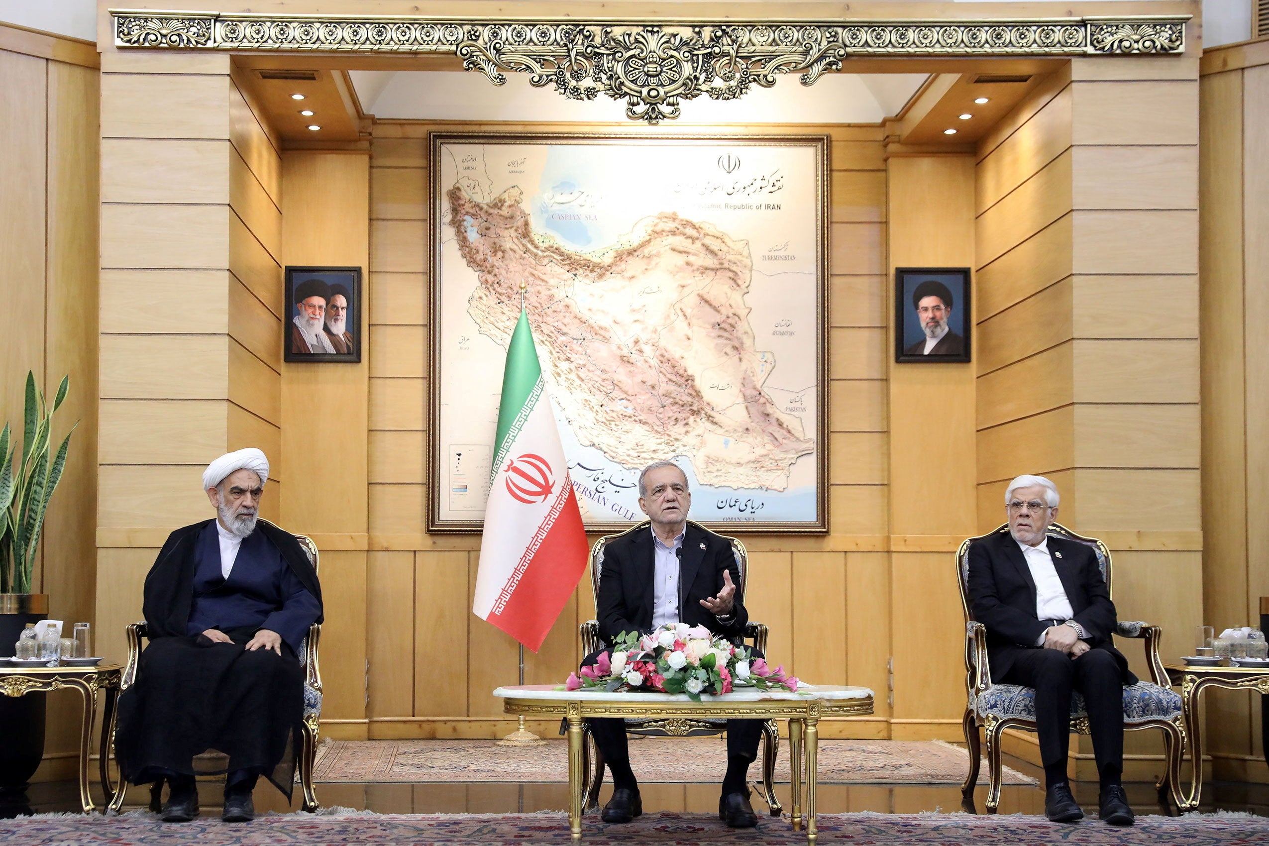 Iran’s president Masoud Pezeshkian (centre) speaks before departing for New York, at Mehrabad Airport in Tehran (Reuters)