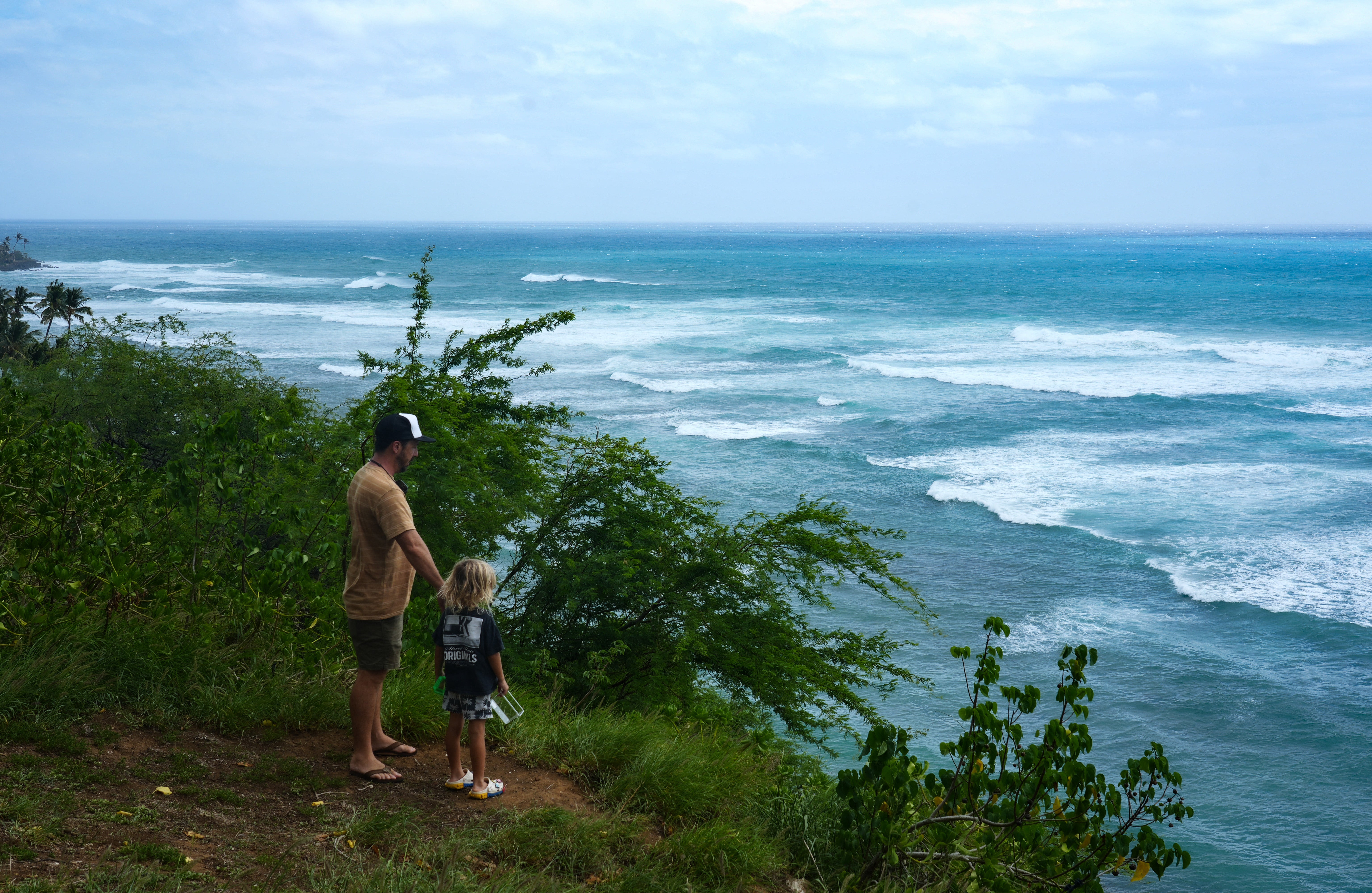 People watch waves build off Diamond Head Beach Park in Honolulu, Hawaii, on September 7, 2026, as surf generated by Tropical Storm Lowell begins to build along Oahu's south-facing shores