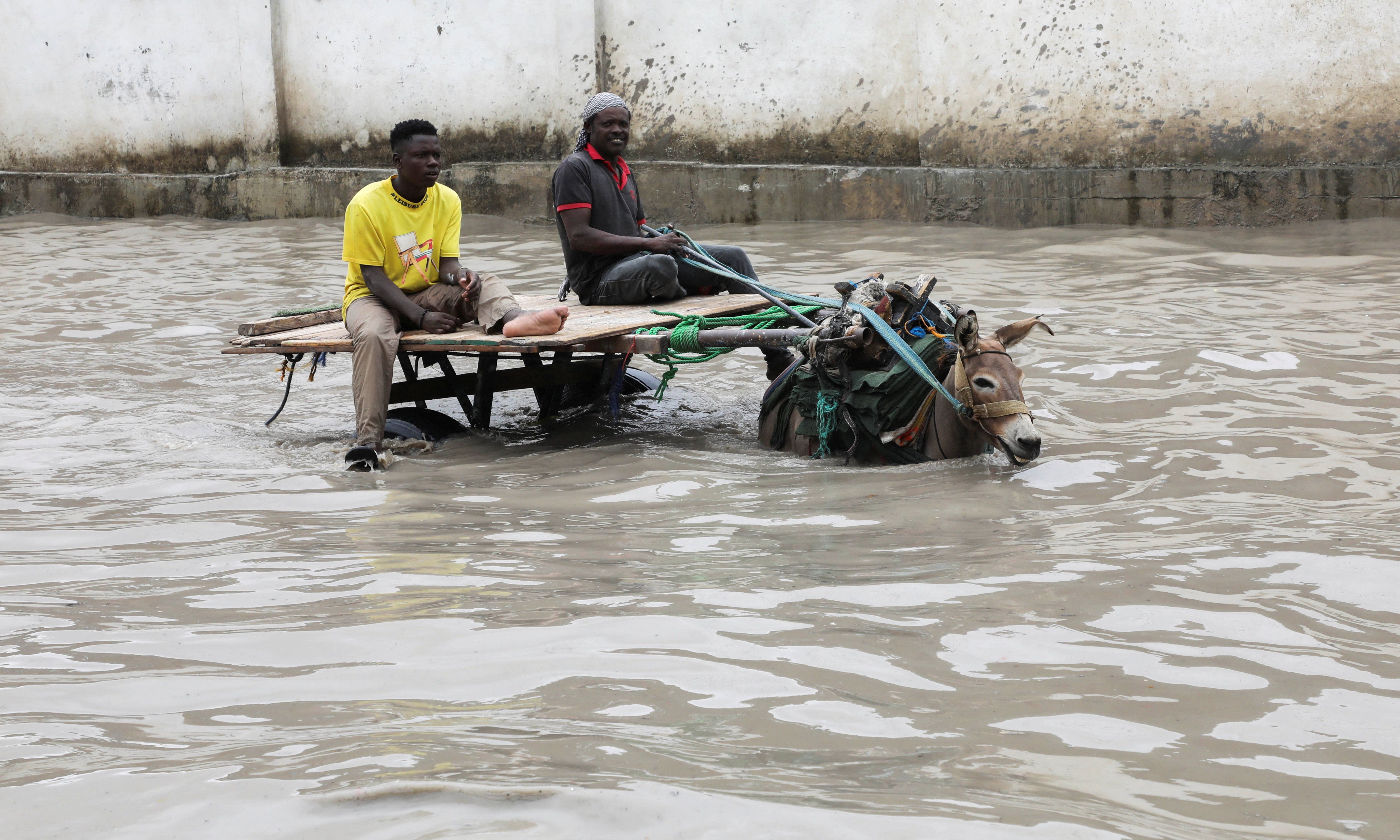 A donkey cart wades through flood waters following a heavy rainfall in Mogadishu, Somalia