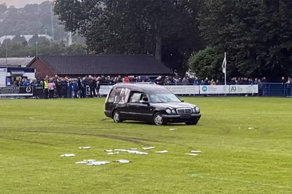 Five men charged after hearse driven onto football pitch forcing match to be abandoned