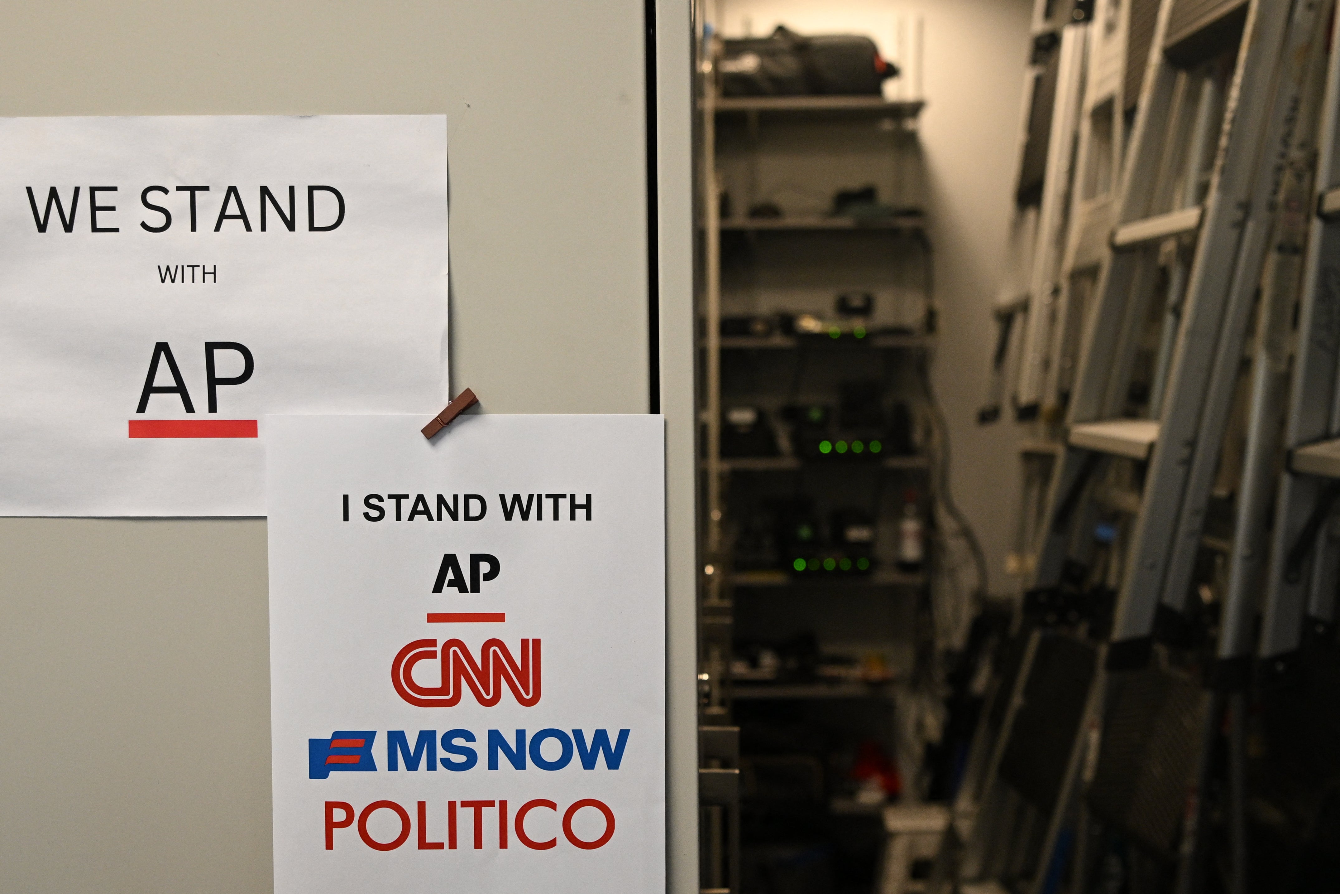Flyers supporting the Associated Press, CNN, MS NOW and Politico hang inside of the White House briefing room in Washington, DC, on September 21, 2026.