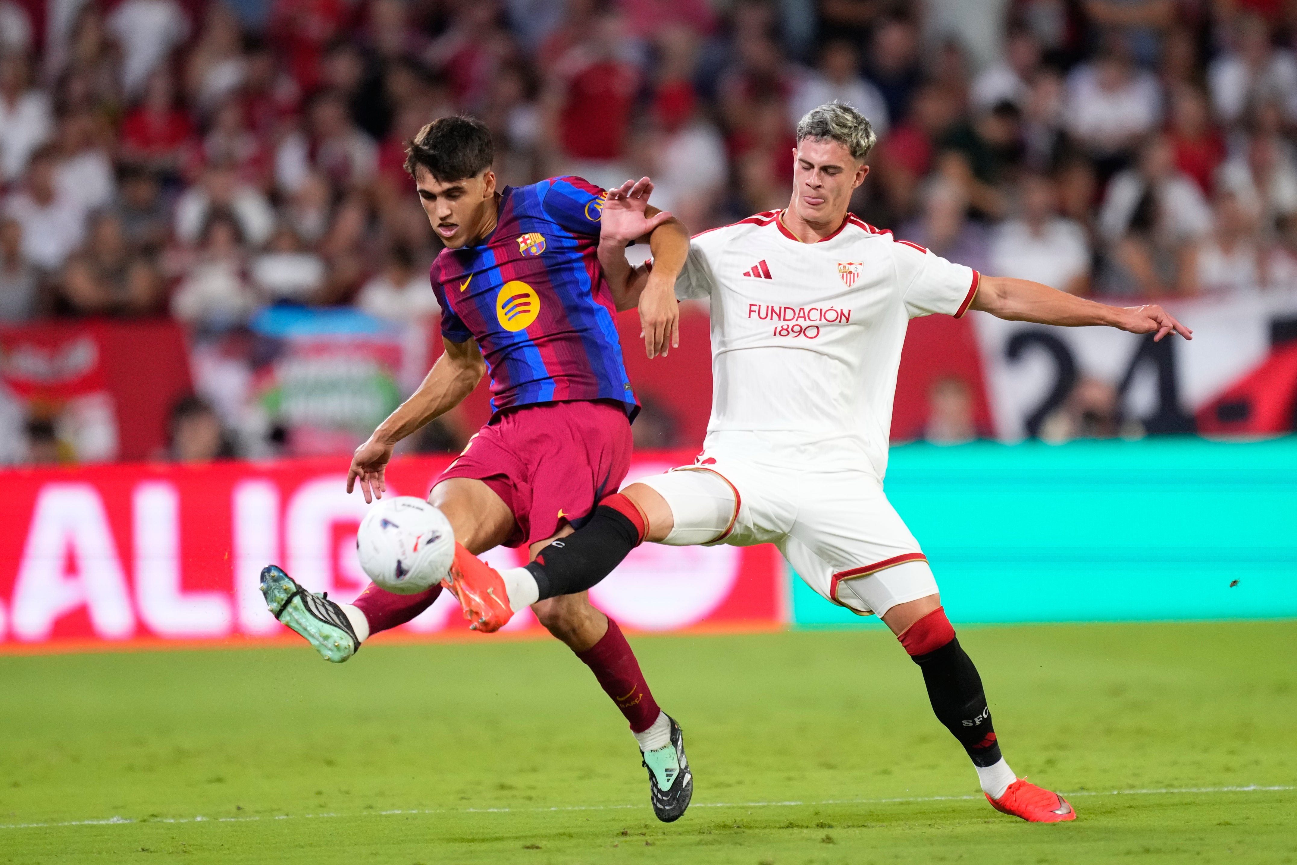 Robbie Ure (right) in action for Sevilla against Barcelona
