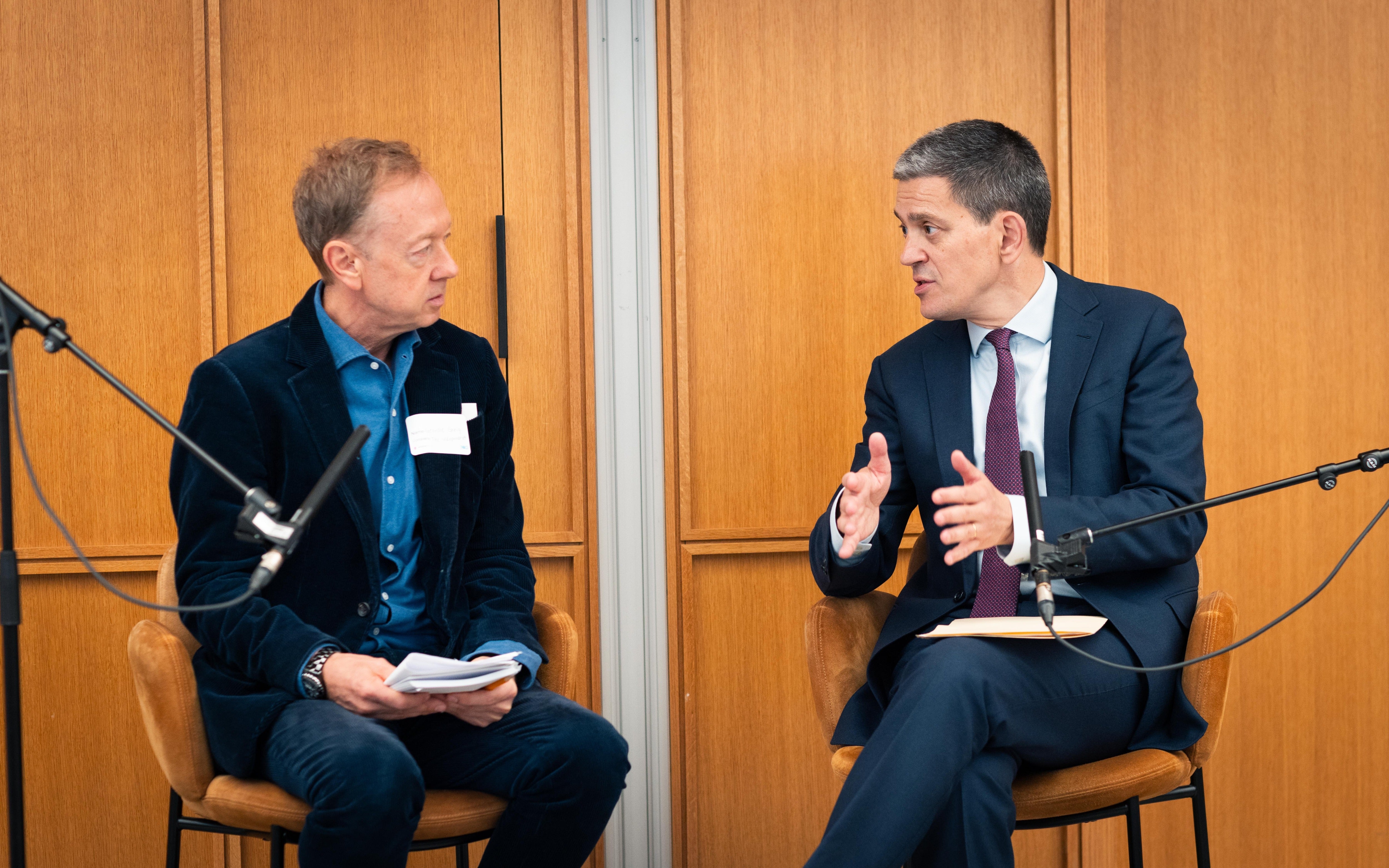 The Independent’s Editor-in-Chief Geordie Greig, left, listens as International Rescue Committee chief executive David Miliband speaks on September 22, 2026, in New York City (Juan M Soria)