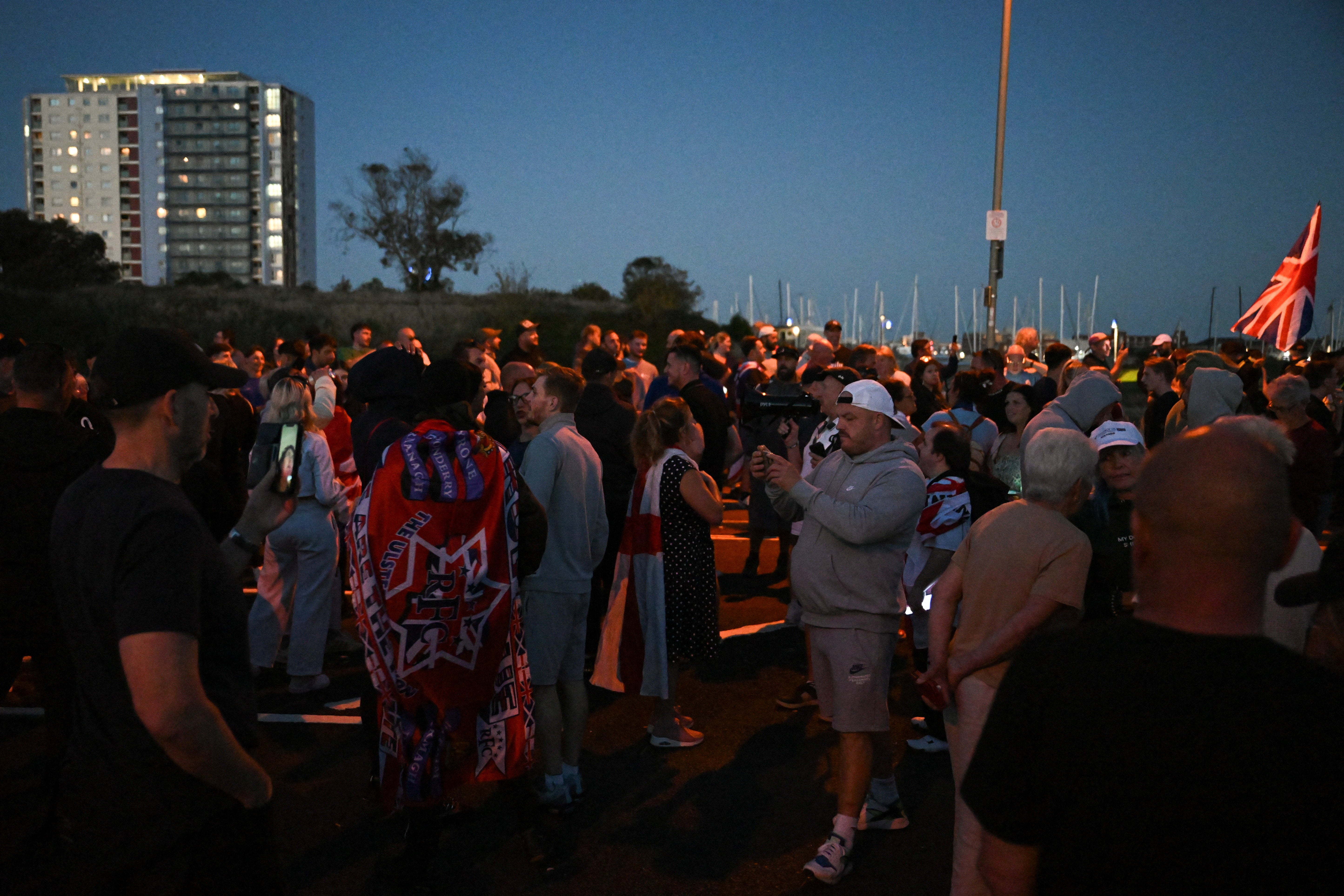 Demonstrators gather during a protest linked to the arrival of a migrant boat