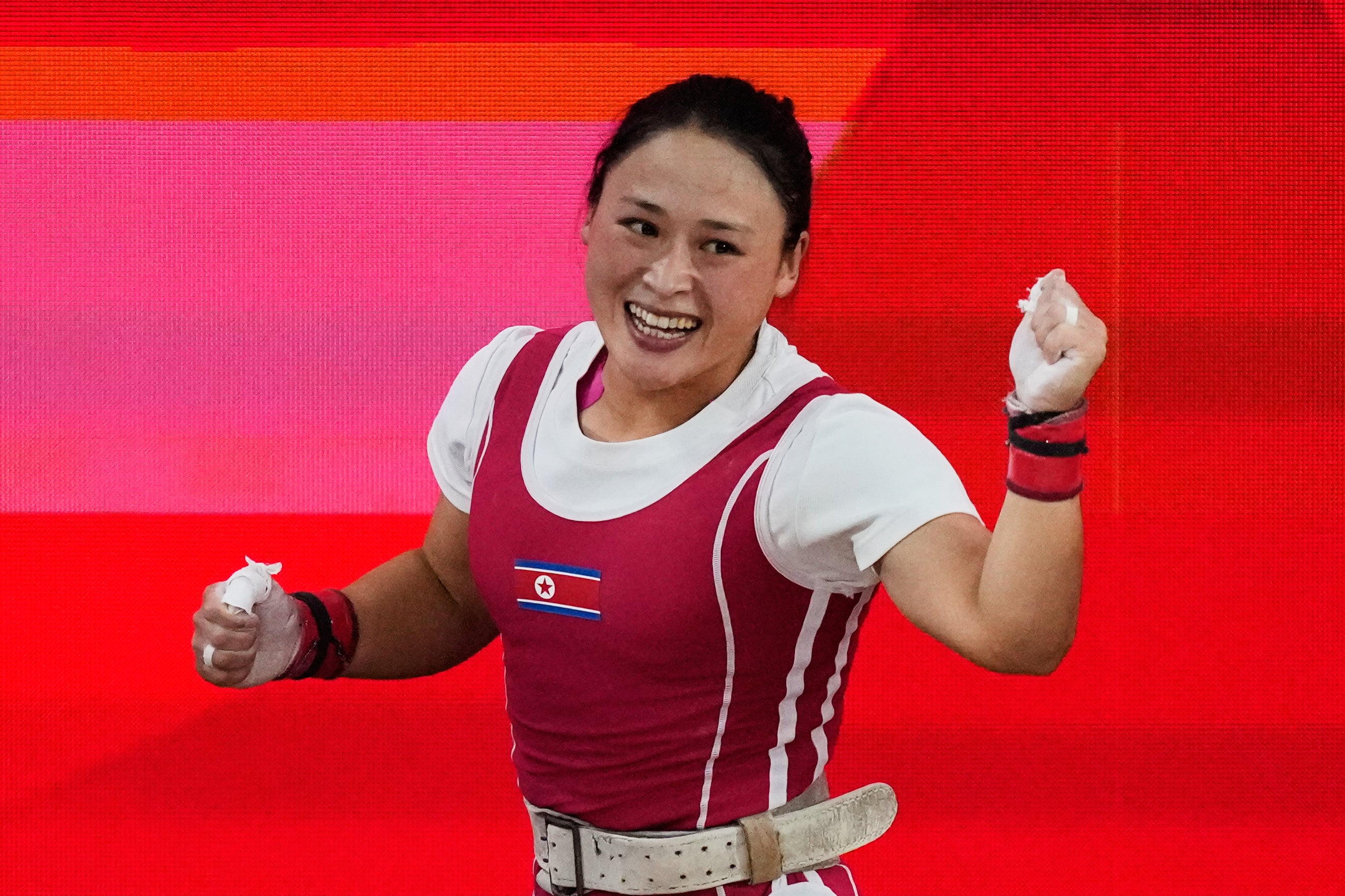 Ri Song Gum of North Korea celebrates after setting a world record during the women's 49kg weightlifting final at the Asian Games in Nagoya, Japan, Wednesday (AP)