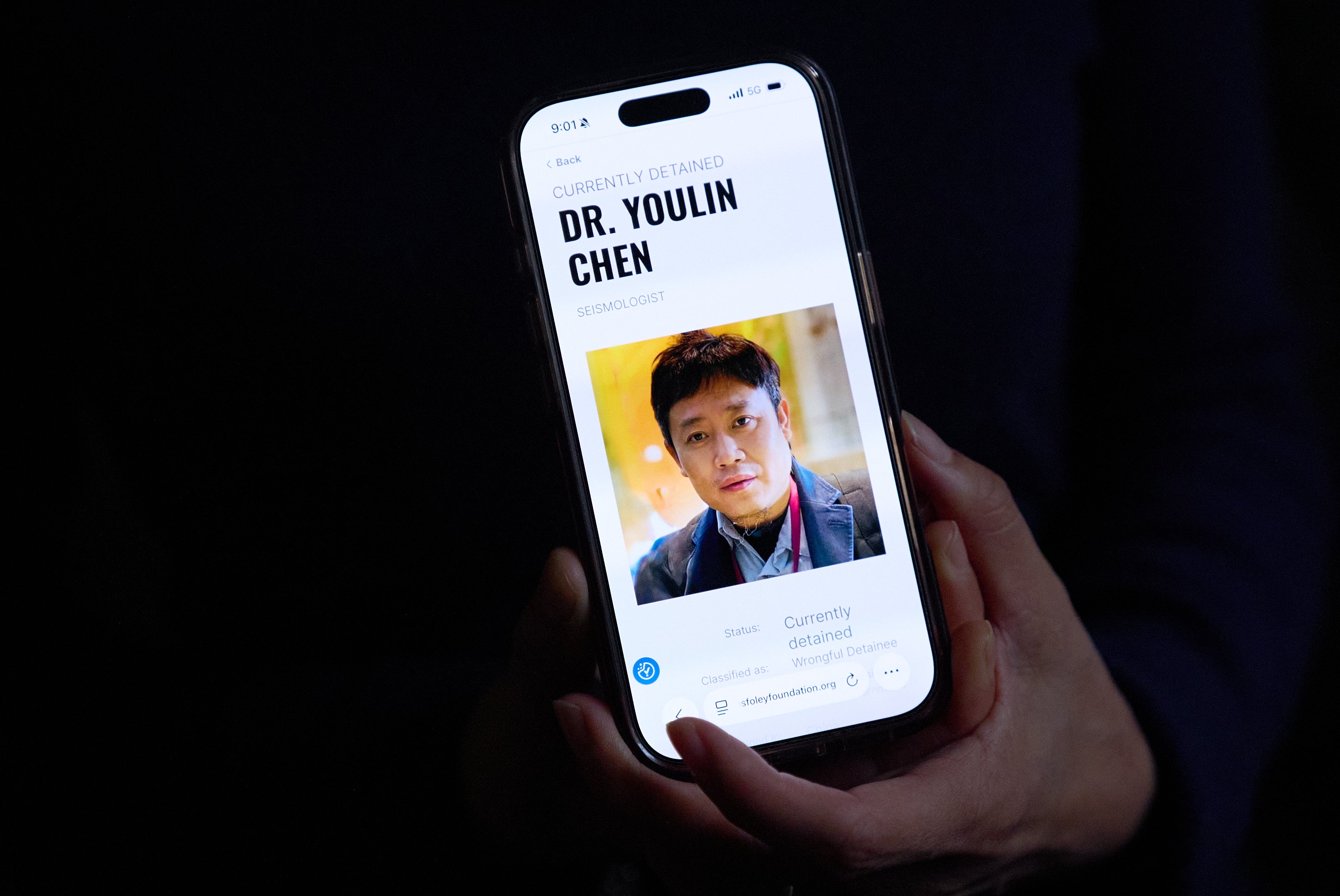 Yufang Rong, wife of U.S. citizen Youlin Chen, who she says has been wrongfully detained in China, holds a photograph of him as seen on a website about detainees