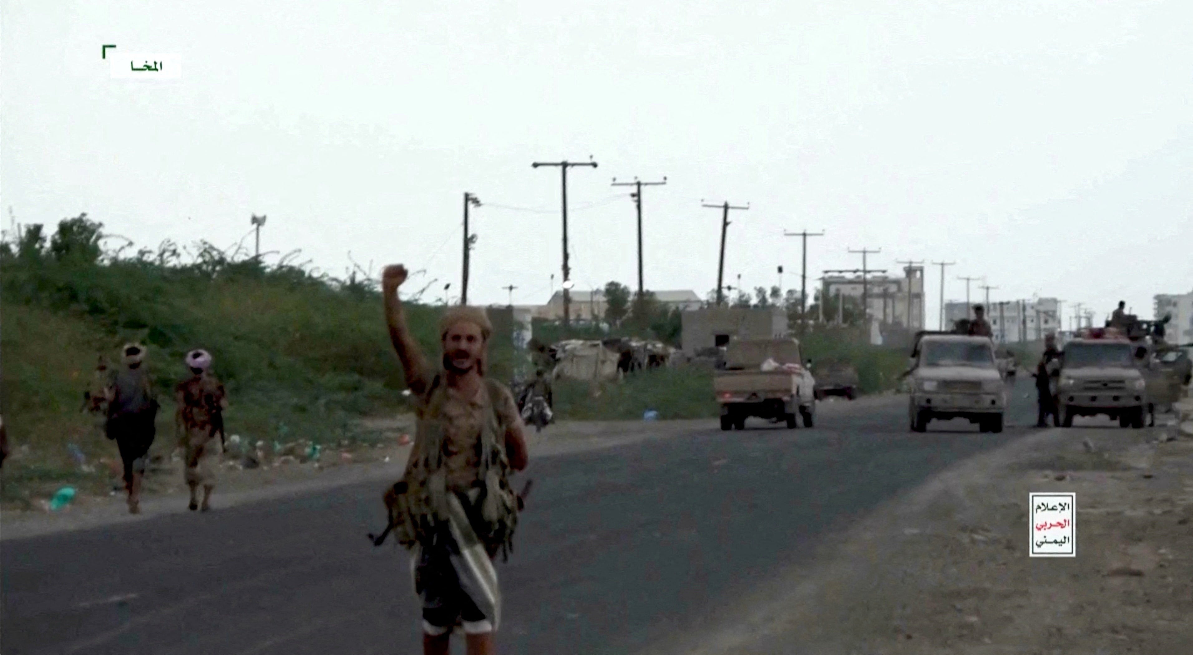 Houthi fighters take to the streets at a location given as Mocha, amid a lightning push west to seize land near the coast (Reuters)