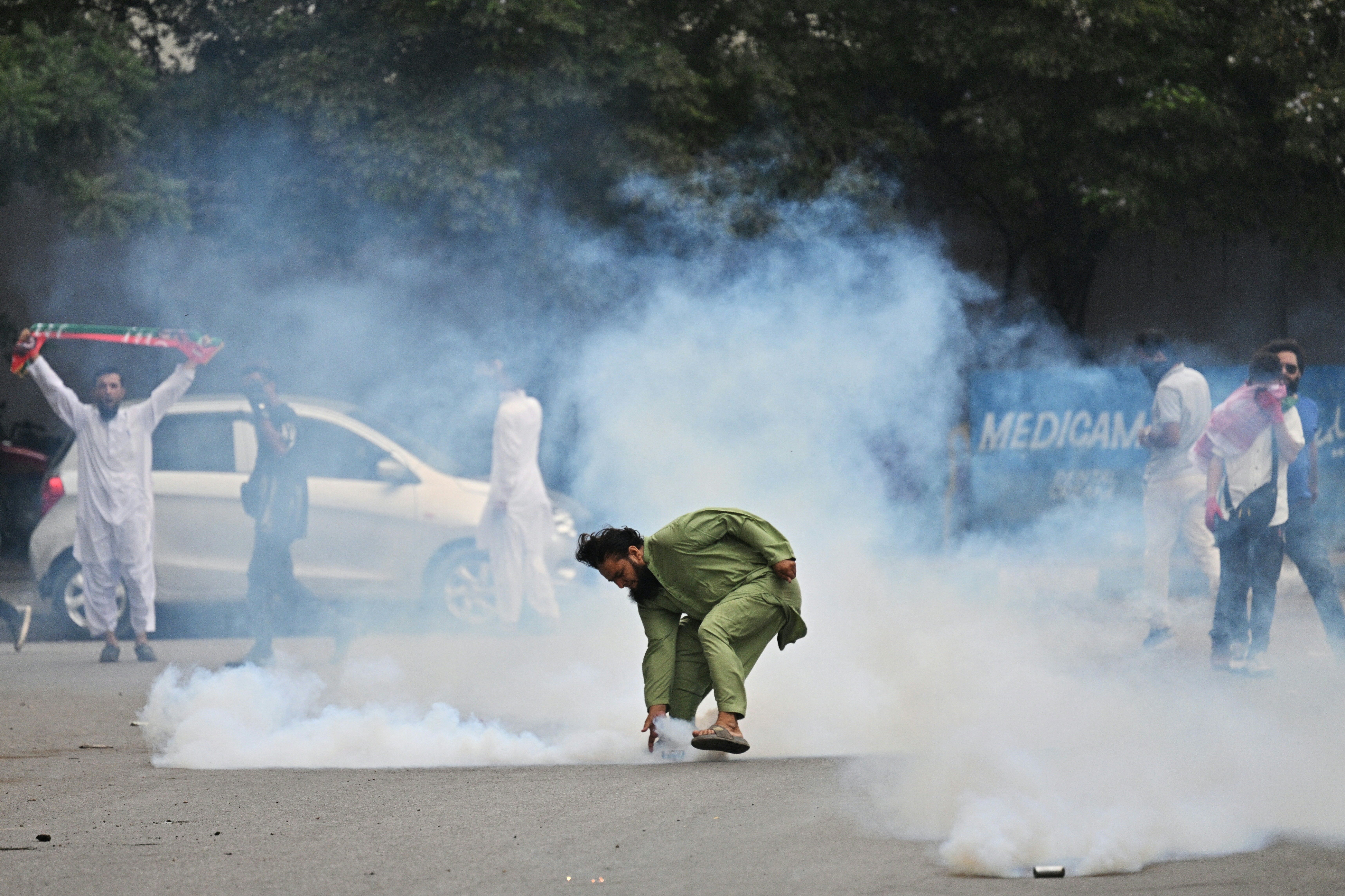 File. A supporter of the Pakistan Tehreek-e-Insaf (PTI) party throws back a tear gas shell as they clash with police during a protest demanding the release of their jailed leader and the country's former prime minister Imran Khan, in Karachi on 5 August 2026 (AFP/Getty)