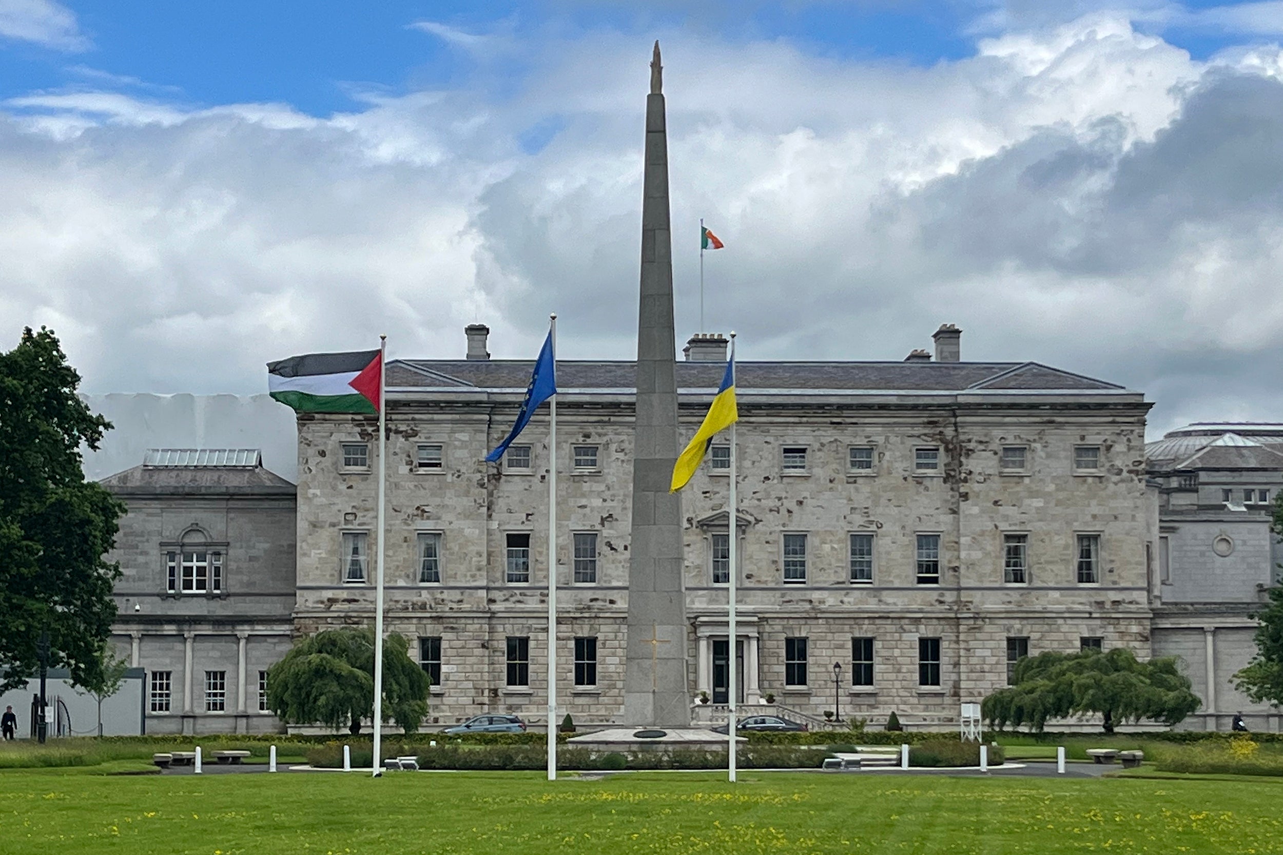 A Palestinian flag flutters alongside EU and Ukrainian flags outside Leinster House to mark Ireland's recognition of a Palestinian state