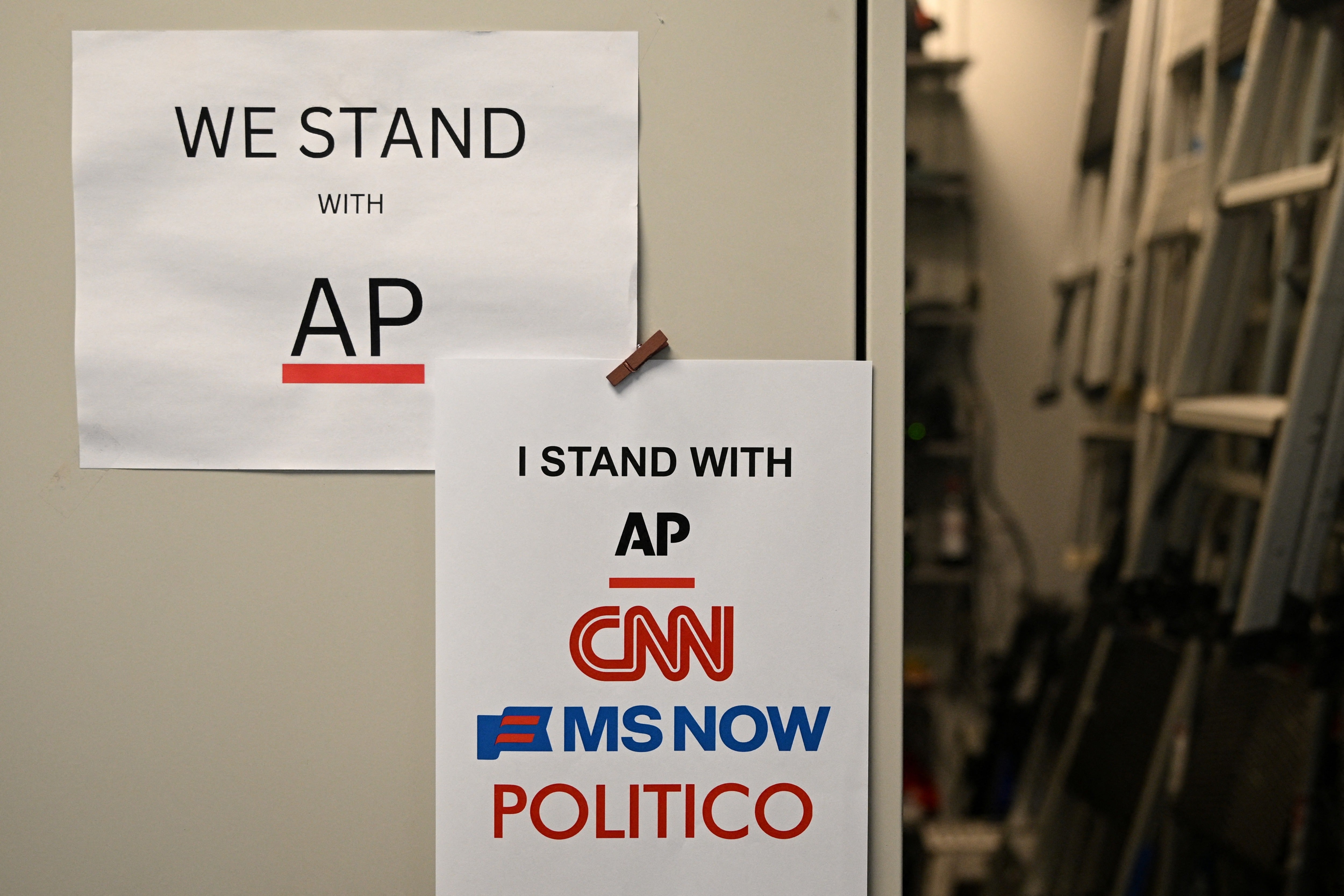 Flyers hang in the White House briefing room in Washington, DC, on September 21, following Trump's media ban
