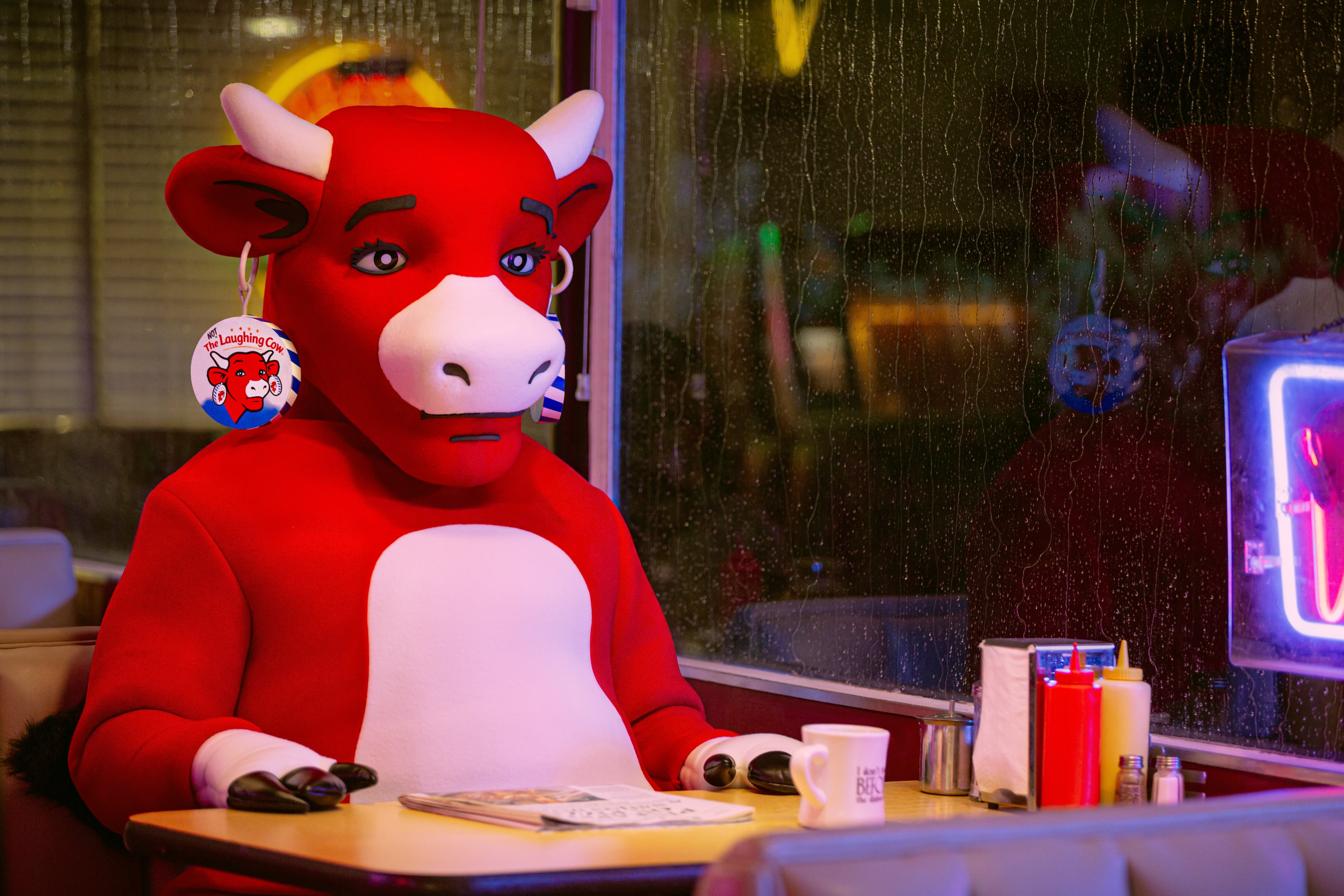 Campaign videos show the usually cheerful mascot looking downcast and alone, including one clip in a diner and another on a swing with ominous messages (The Laughing Cow)