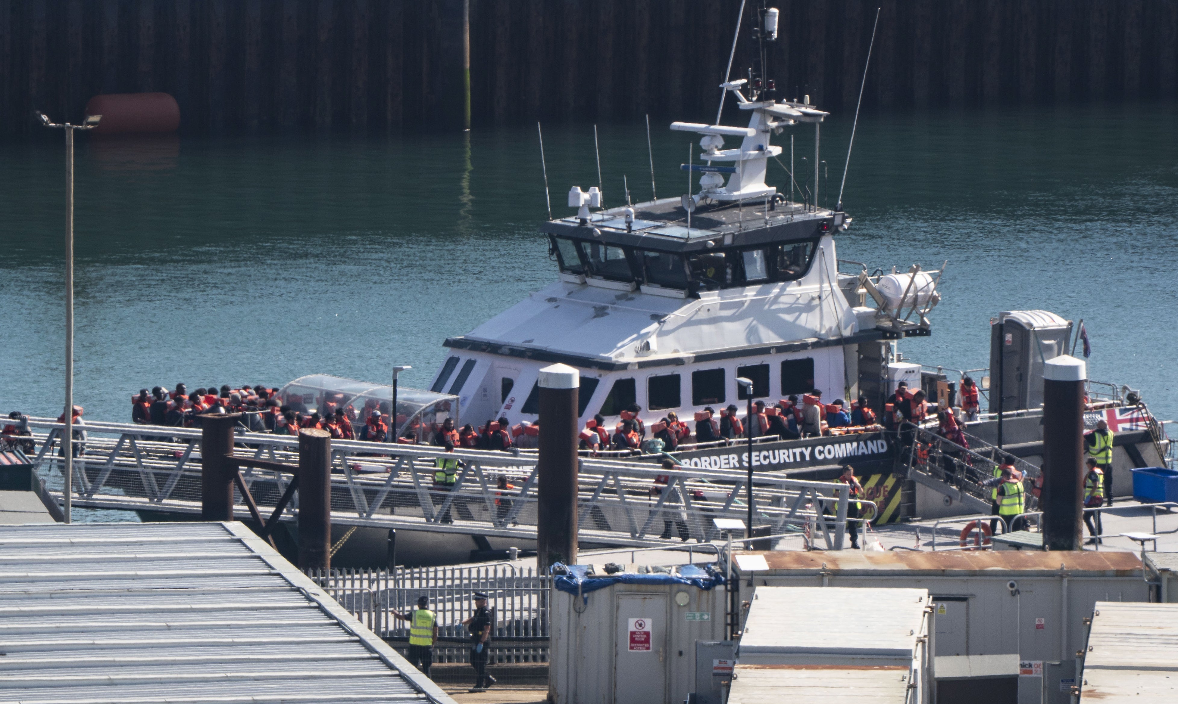 A group of people thought to be migrants are brought in to the Border Security Command compound (Gareth Fuller/PA) (PA Wire)