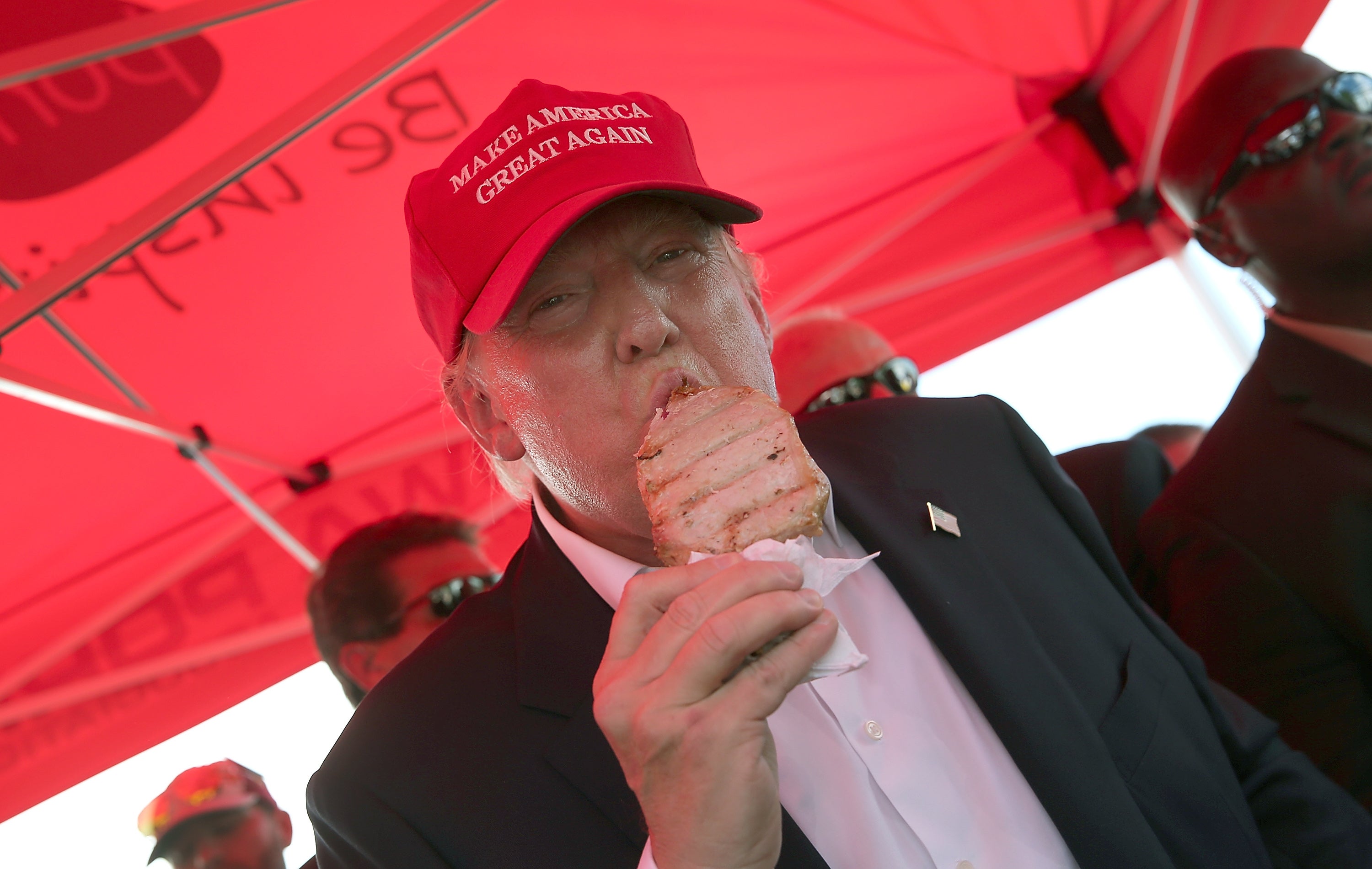 Republican presidential candidate Donald Trump eats a pork chop on a stick while attending the Iowa State Fair on August 15, 2015 in Des Moines, Iowa.