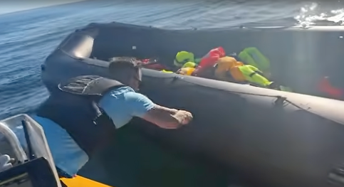 Far-right activist Danny Tommo can be seen slashing the dinghy with a blade