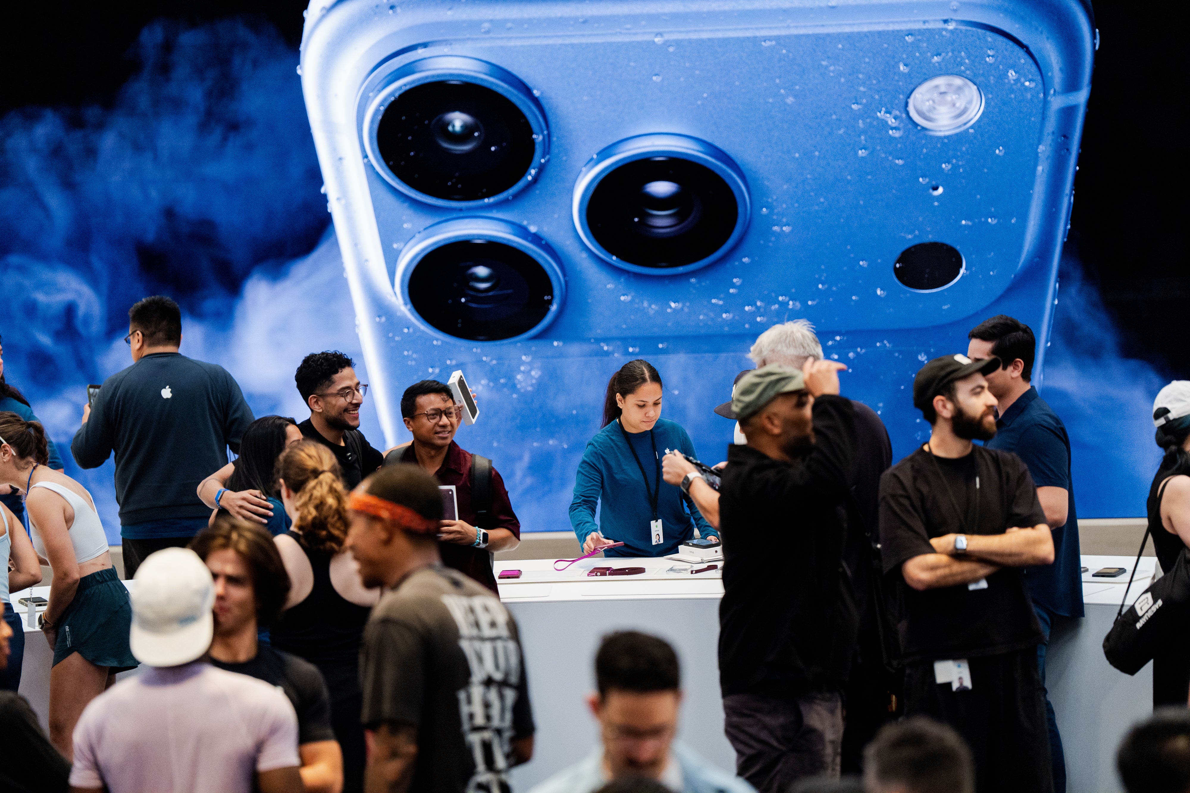 People shop at the Apple store on Fifth Avenue on the day of Apple's launch of the iPhone 18 Pro (AP Photo/Angelina Katsanis)