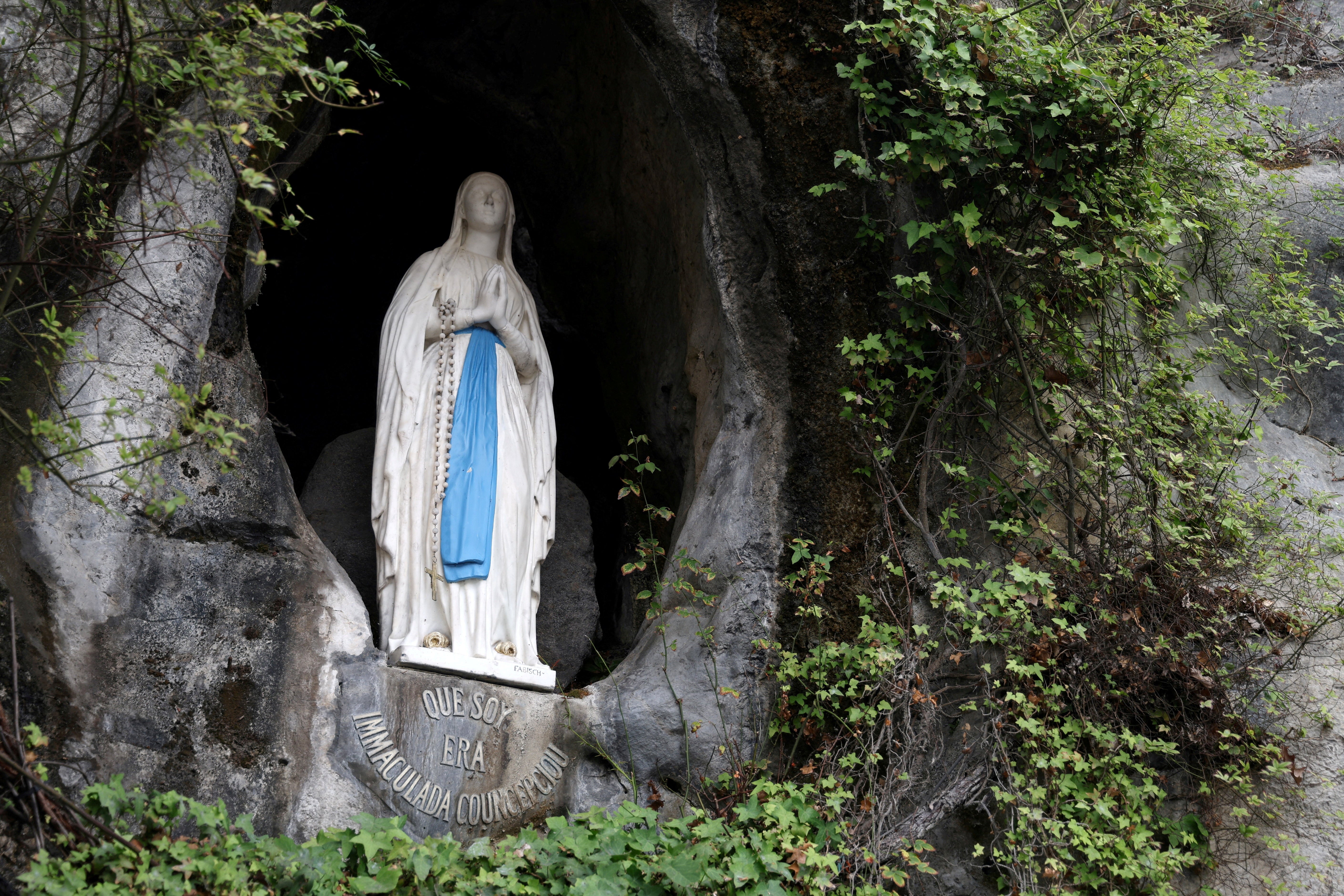The statue of Our Lady of Lourdes, in the niche at the Grotto of the Apparitions, also called Grotto of Massabielle