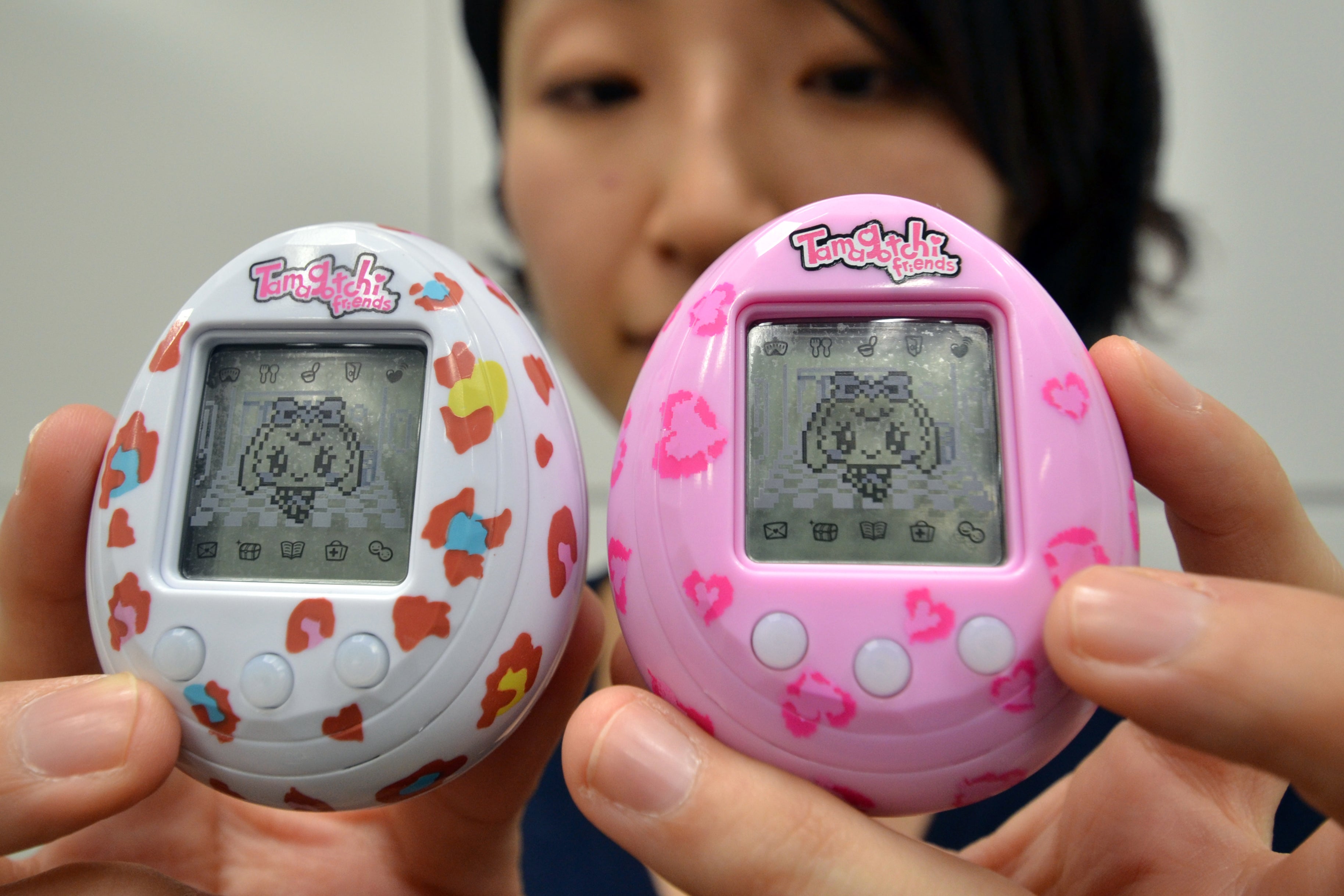 Japanese toy giant Bandai employee Tomomi Washizu displaying the Tamagotchi virtual pet toy release 'Tamagotchi Friends' (AFP/Getty)