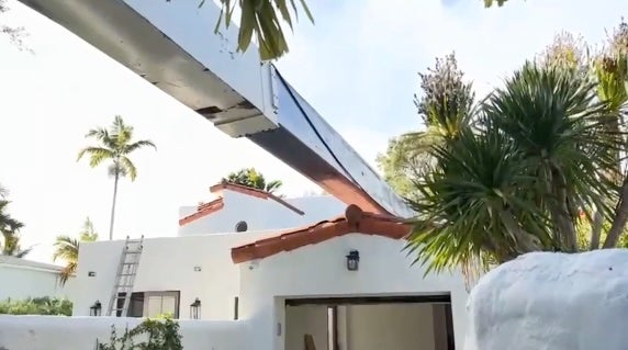 A second crane has toppled onto a home in Fort Lauderdale, Florida, while fire crews tried to use it to remove the first fallen crane