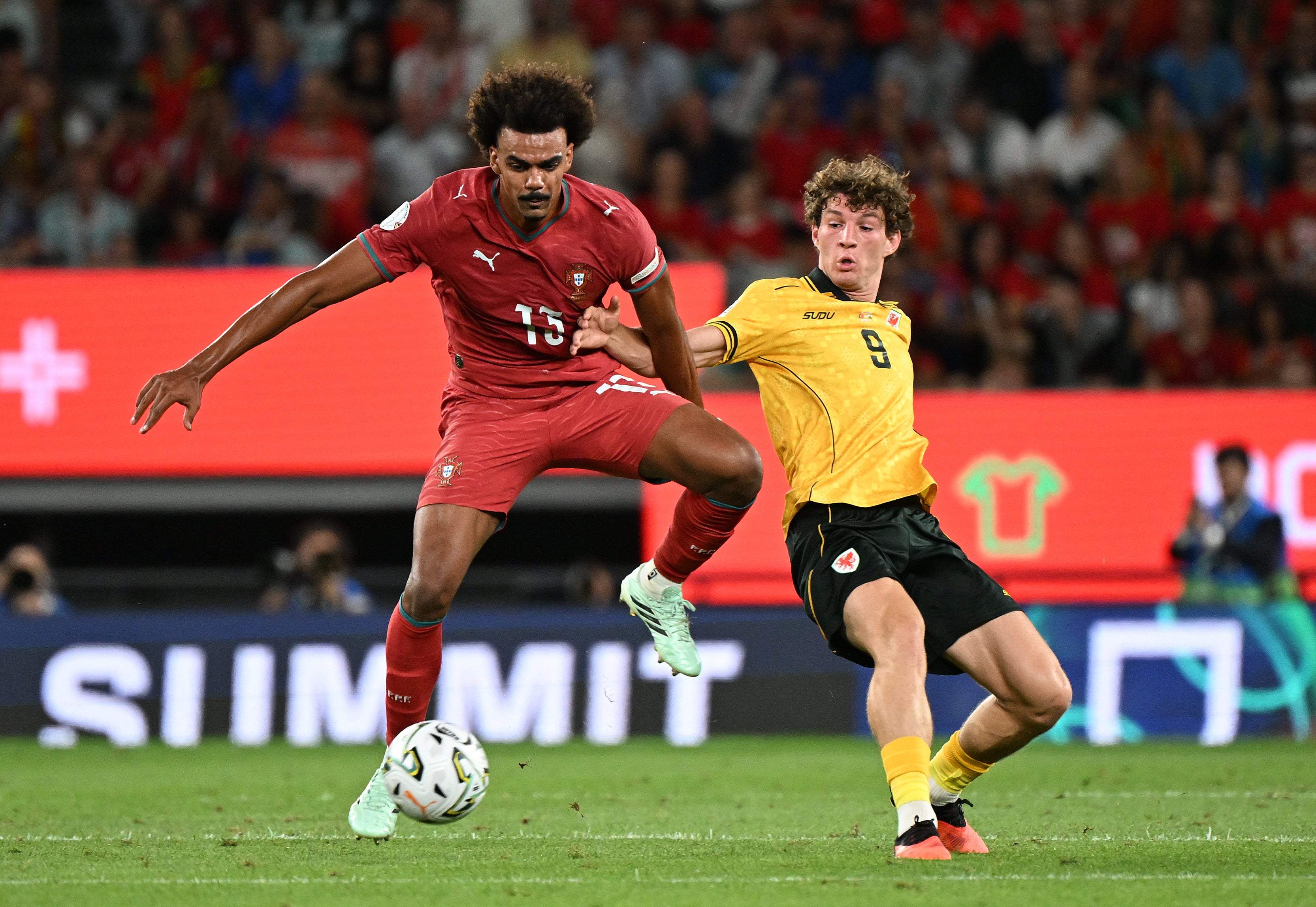 Portugal’s Renato Veiga (left) and Wales’ Lewis Koumas battle for the ball (Zed Jameson/PA)
