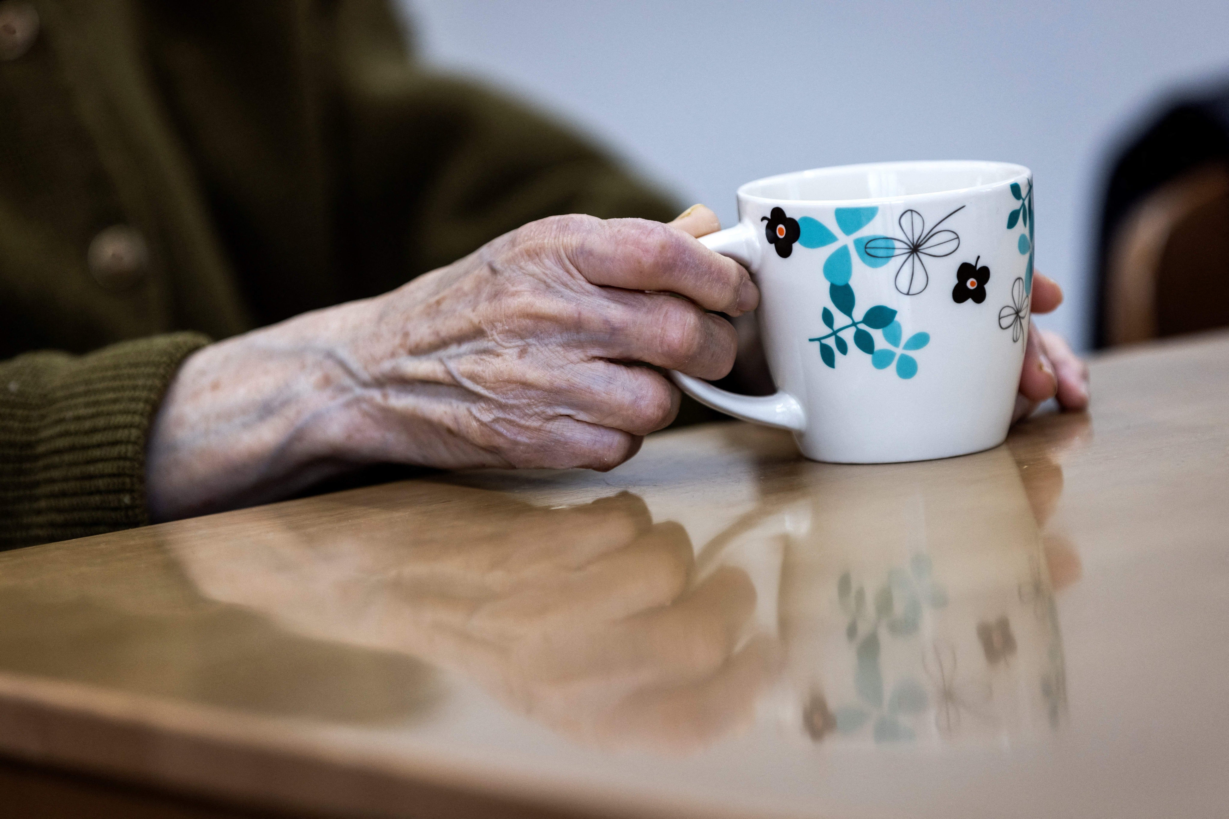An elderly woman is photographed