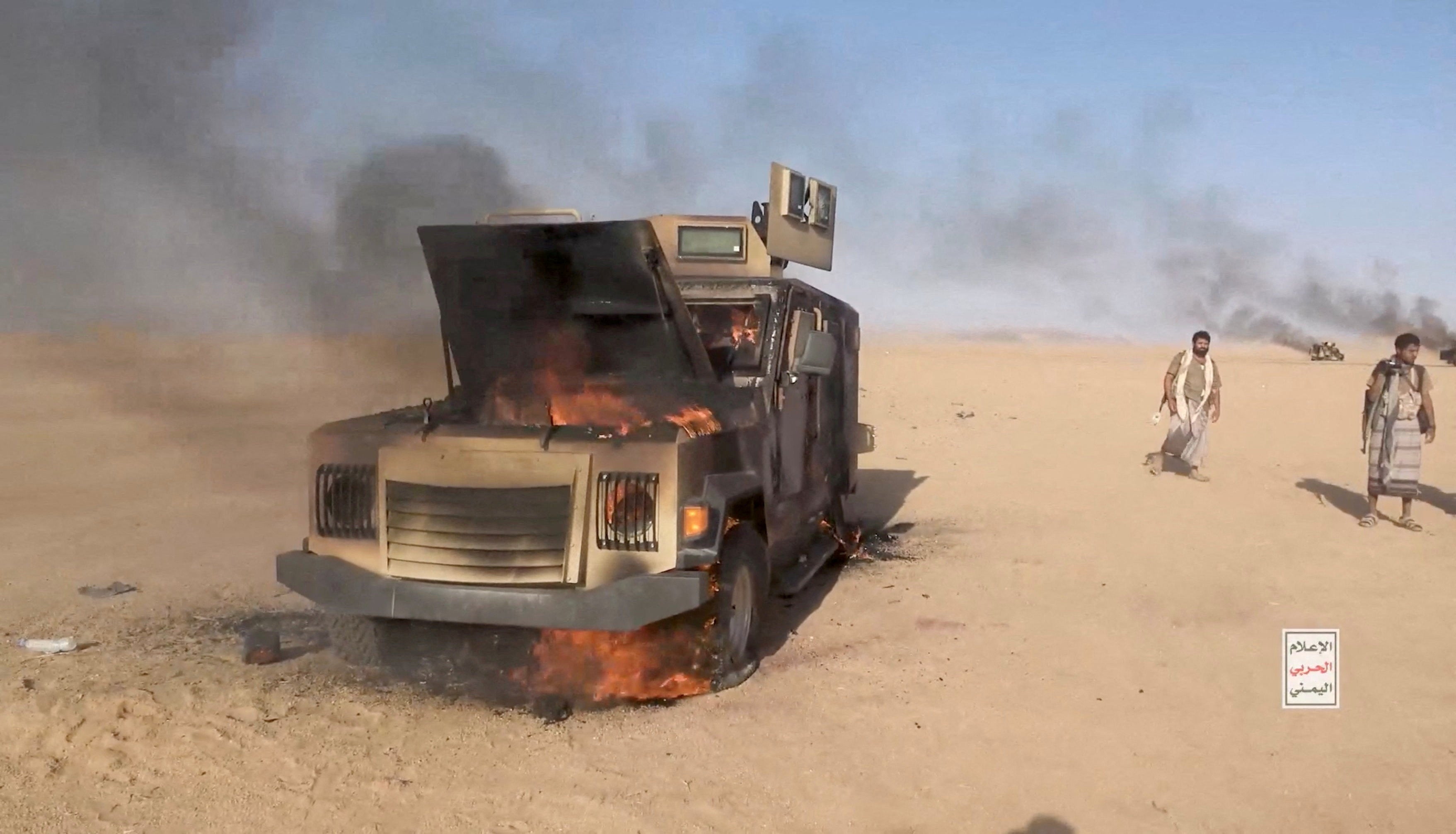 File: Houthi fighters move next to a destroyed vehicle following what the source described as an attack on Saudi-backed forces in the location given by the source as al Jawf governorate, Yemen (Reuters)