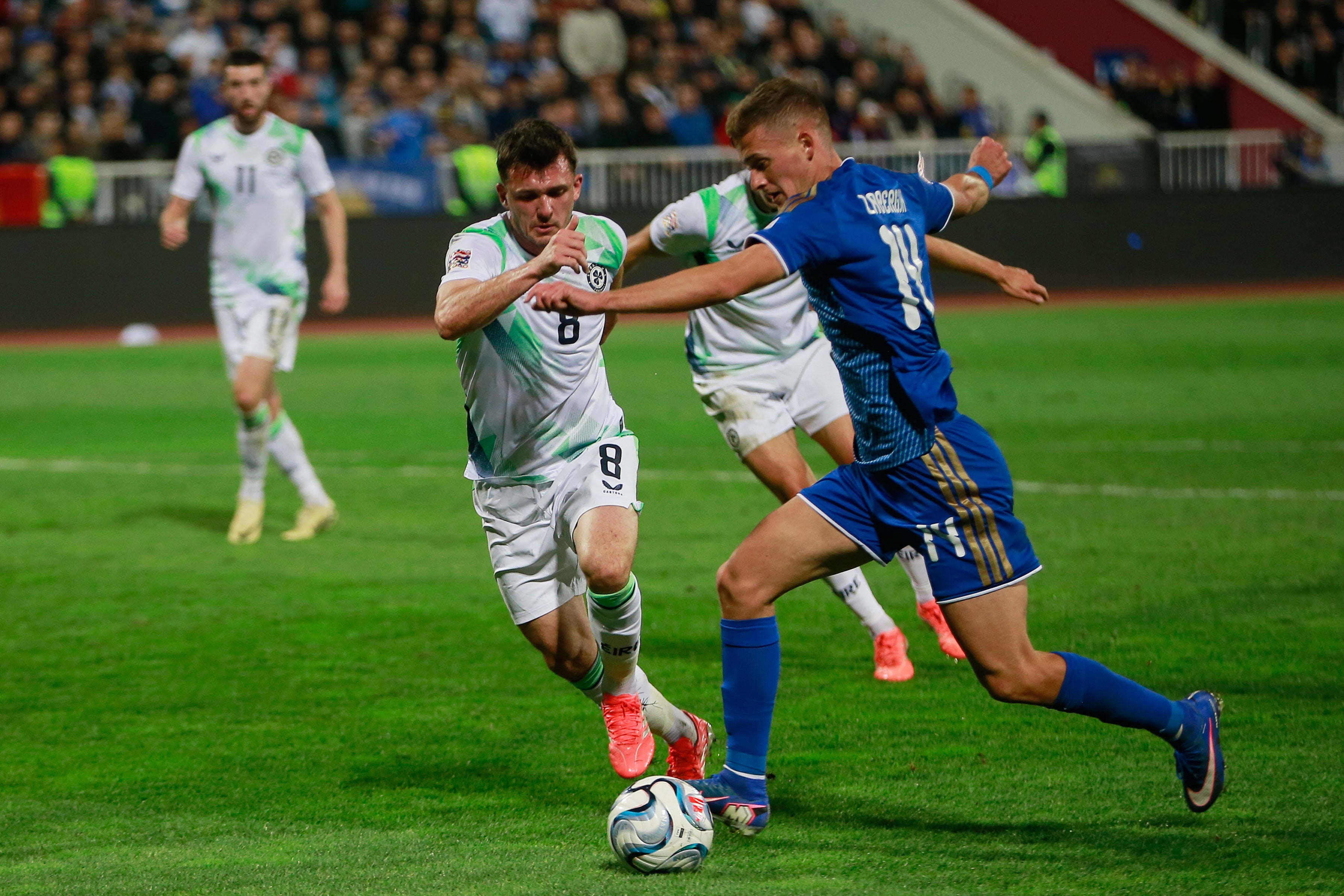 Kosovo's Baton Zabergja, right, challenges for the ball with Ireland's Jason Knight