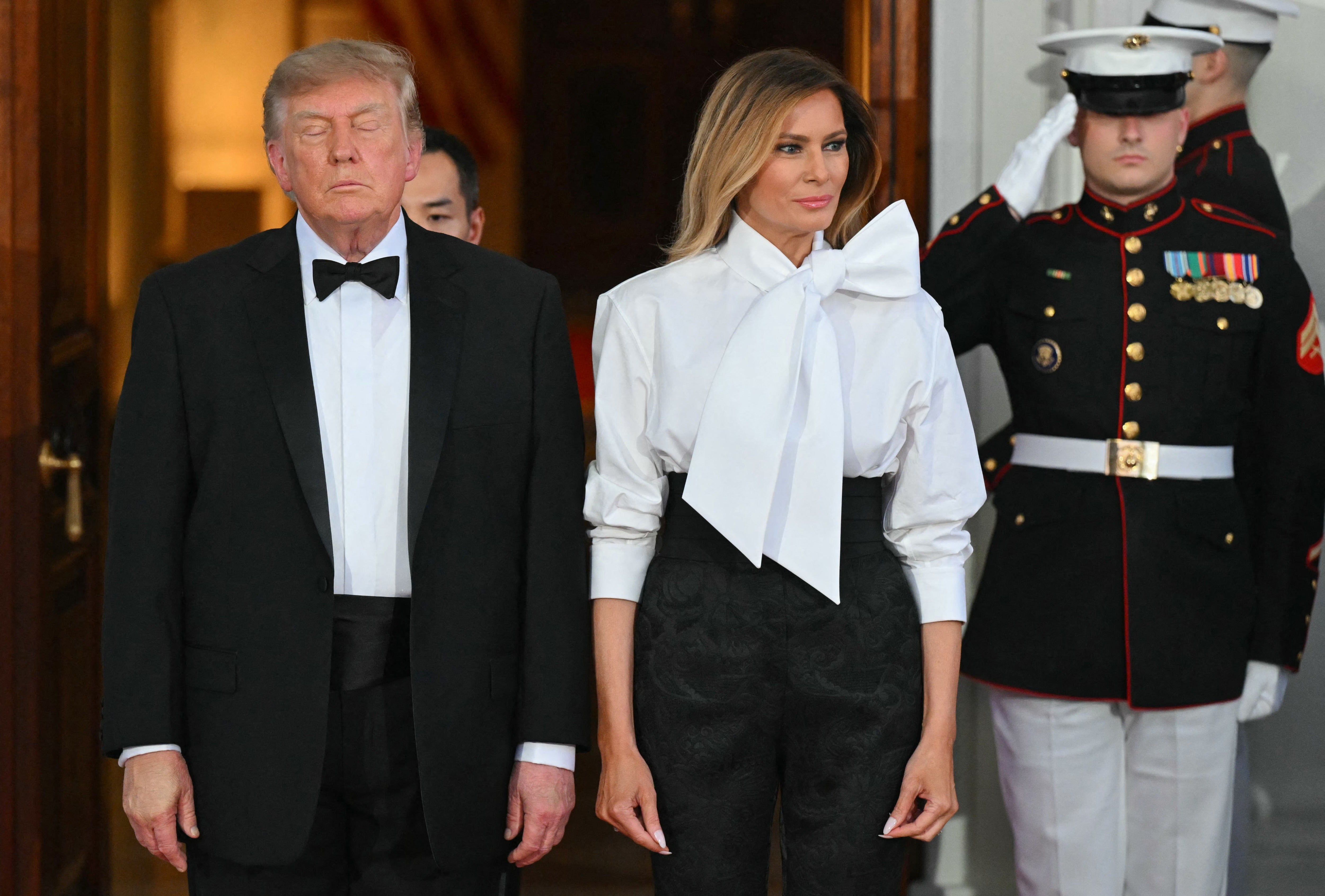 Trump was photographed, with makeup caked on his left hand used to cover bruising, next to first lady Melania Trump while waiting to greet Xi and his wife Liyuan Peng at the White House ahead of the dinner