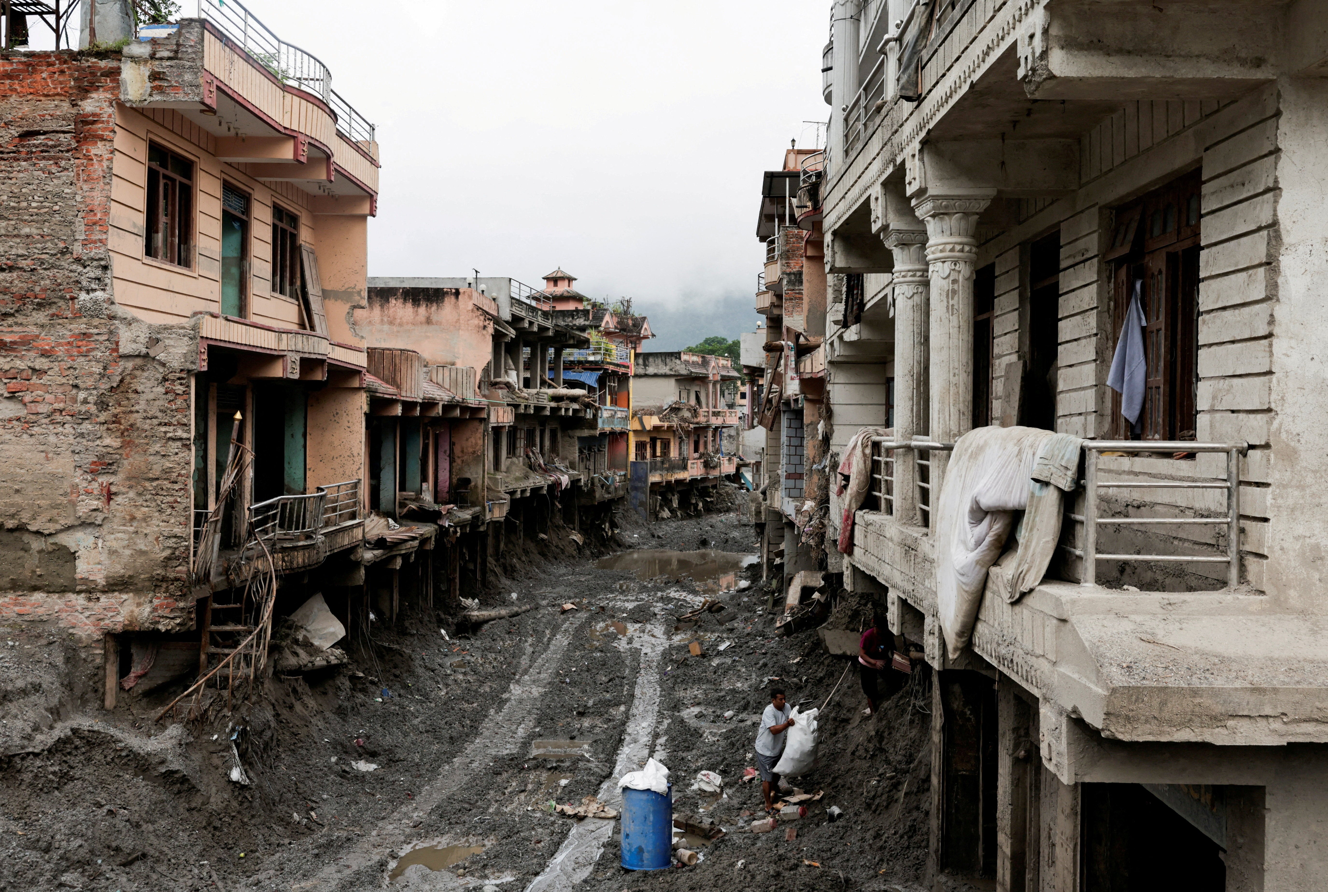 People search for their belongings at a damaged house in Devighat, Nepal, this week (Reuters)