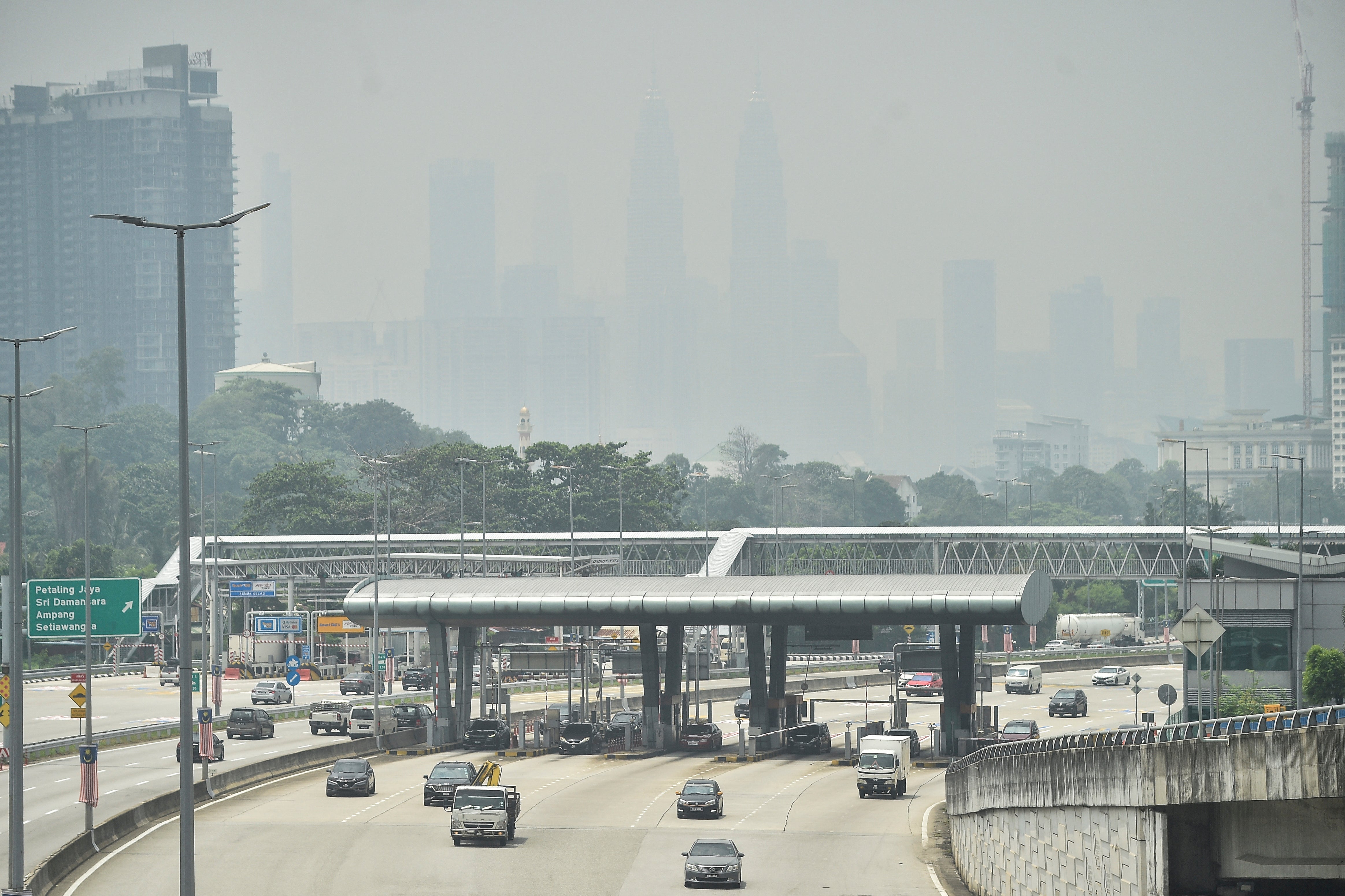 The Petronas Twin Towers (background C) and other buildings are seen shrouded by haze in Kuala Lumpur (AFP/Getty)