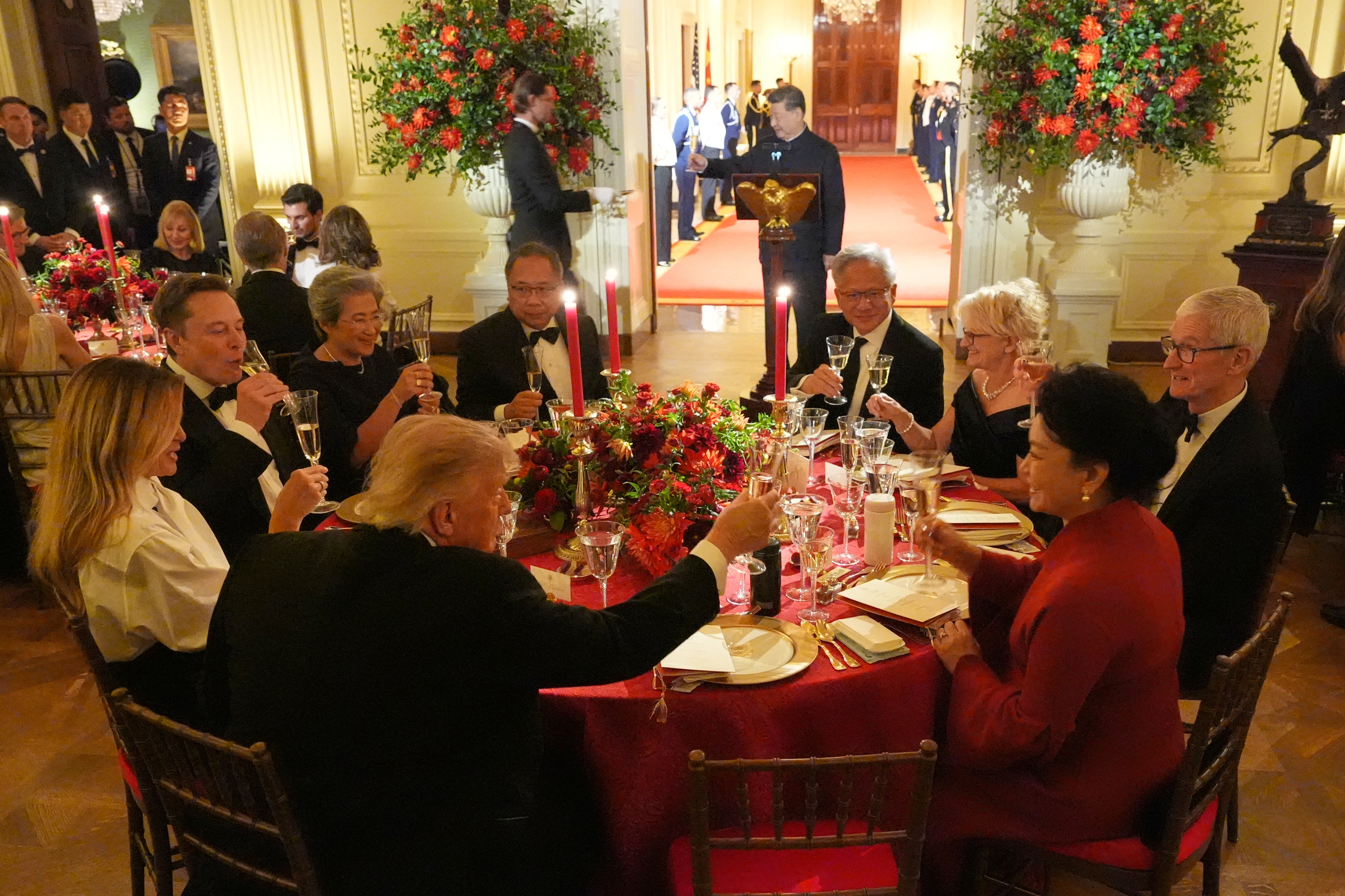 Trump dined with President Xi (seen standing), Apple’s Tim Cook (right) and SpaceX’s Elon Musk (left)