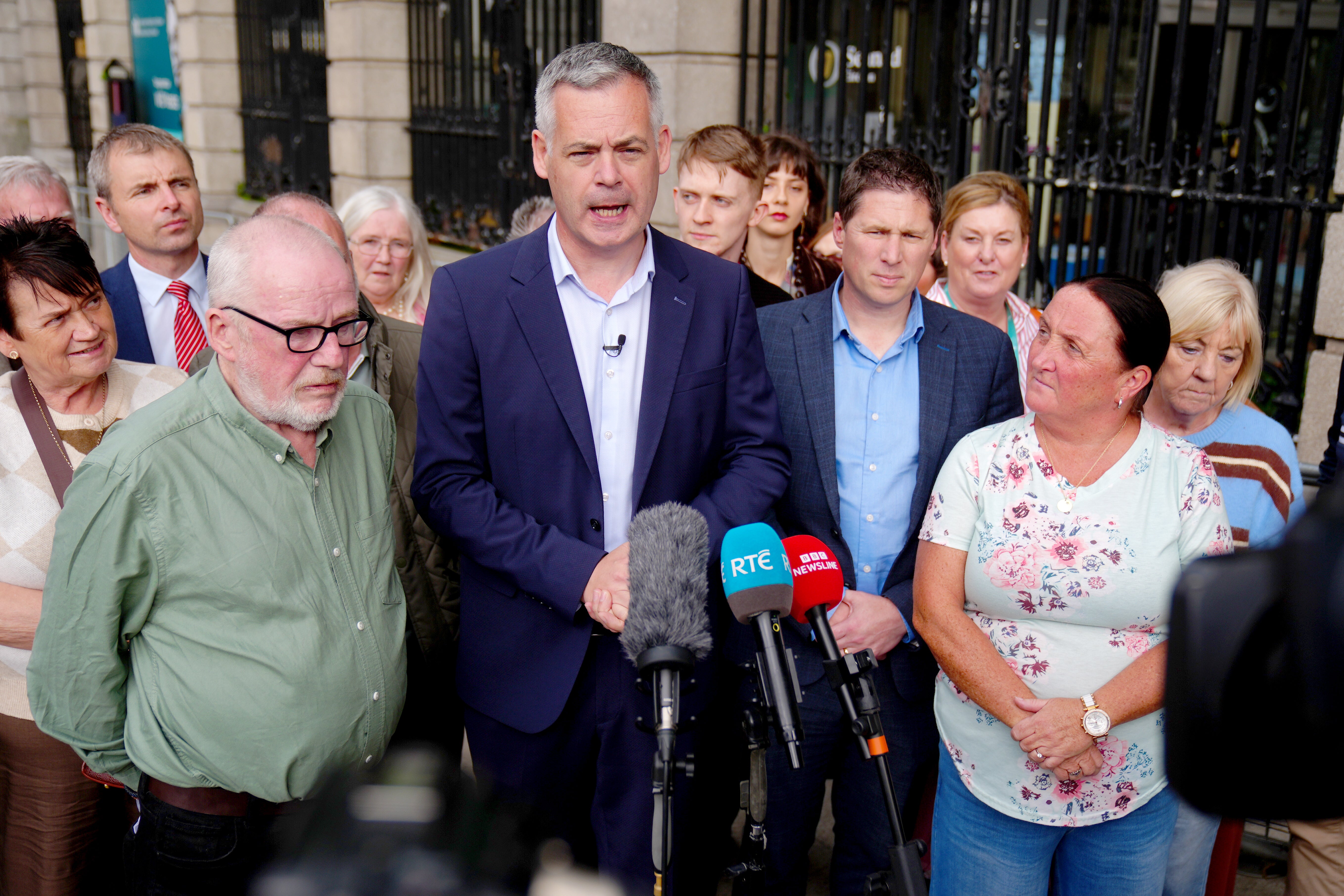 Sinn Fein TDs Pearse Doherty (centre) and Matt Carthy (centre right) with Vincent McAleenan (left) and Linda O'Neill (second right), with members of the Garvaghy Road Residents Coalition, which is against a proposed Orange Order parade through the street in Co Armagh this weekend (PA)