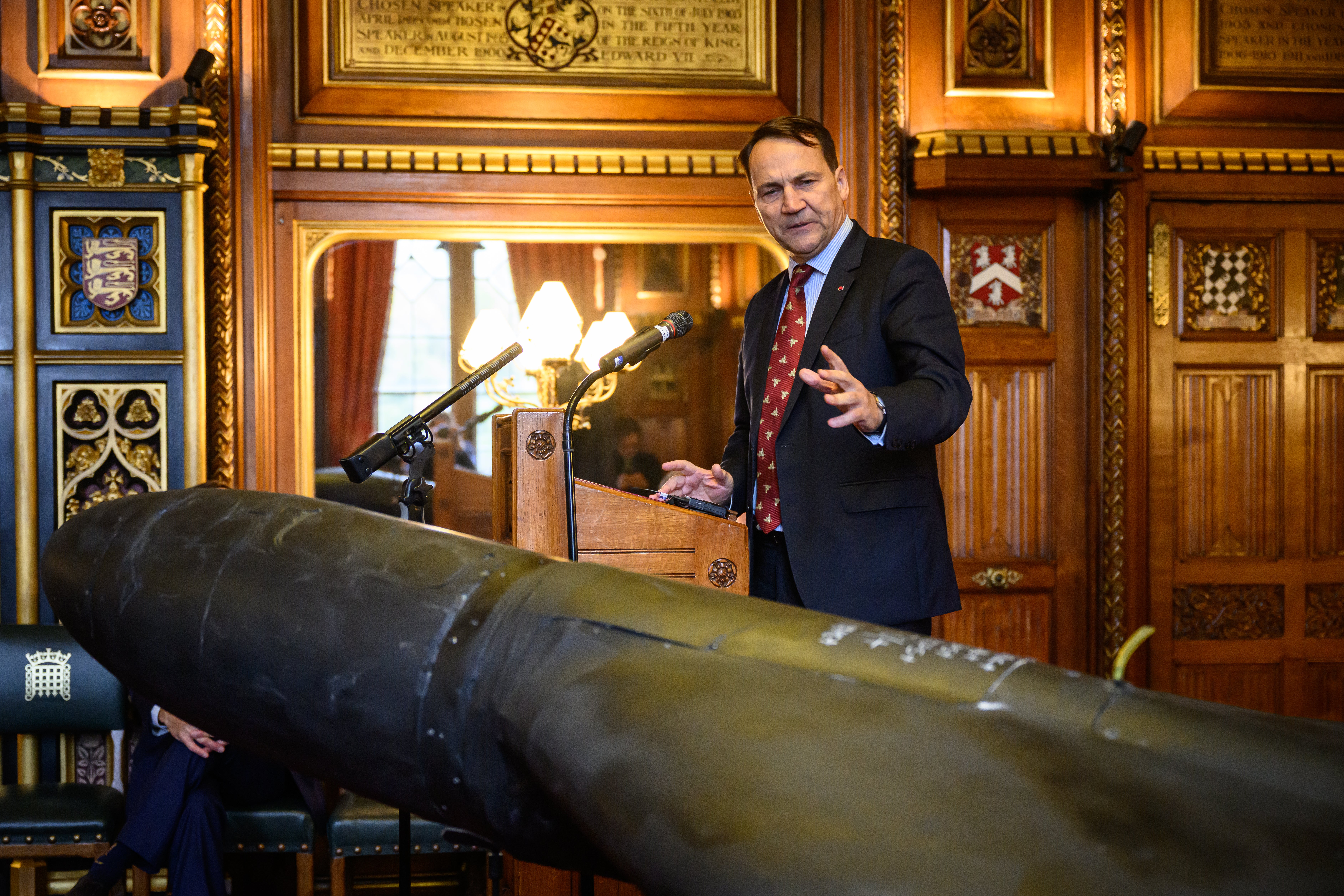 Radek Sikorski, the Minister of Foreign Affairs of Poland, speaks near downed Iranian-made Shahed-136 attack drone, used by Russia in Ukraine, unveiled at the Houses of Parliament on October 14, 2025 in London (Getty)