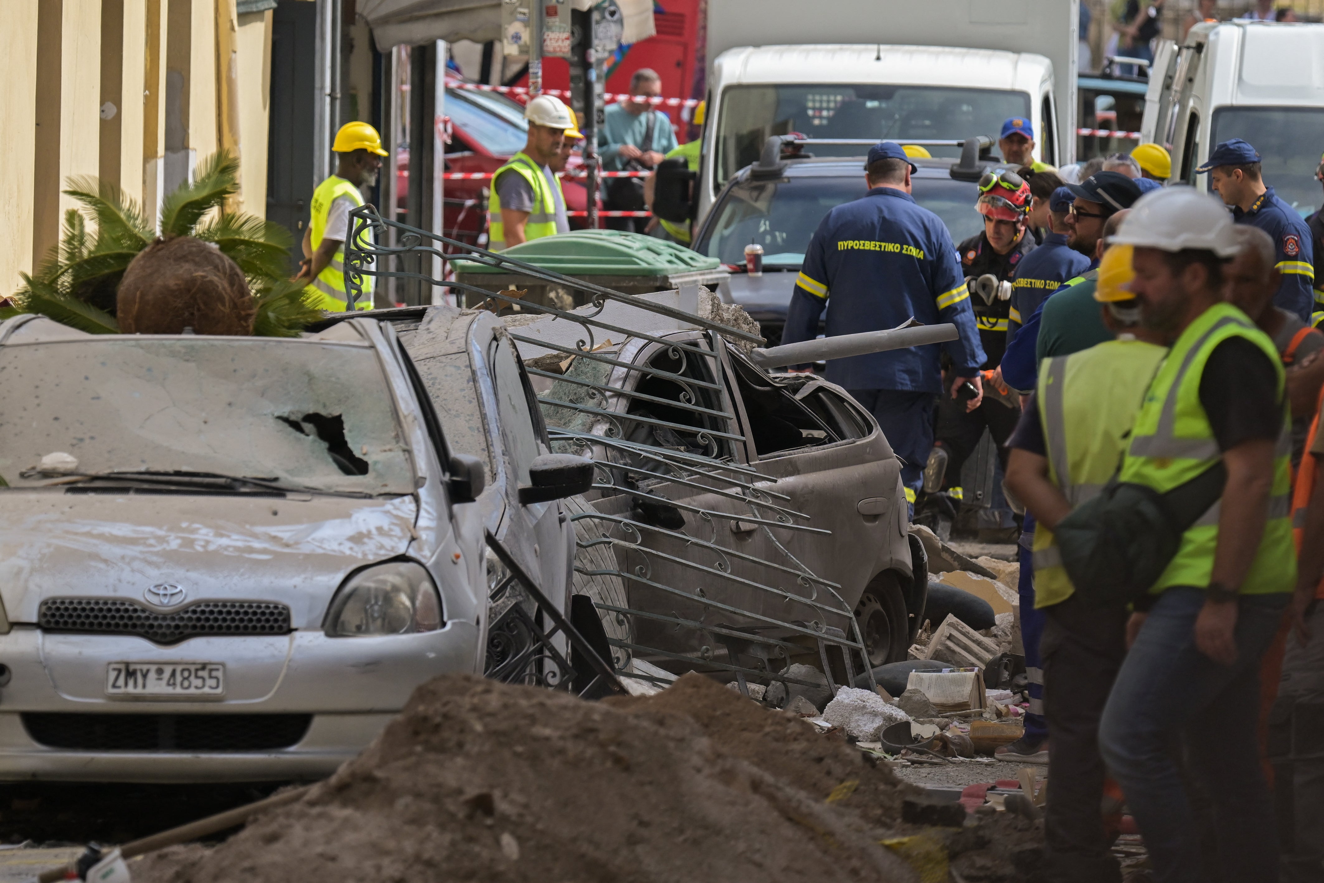 Emergency personnel operate at the site of an old building that partially collapsed following an explosion in the Plaka area of central Athens on September 25, 2026