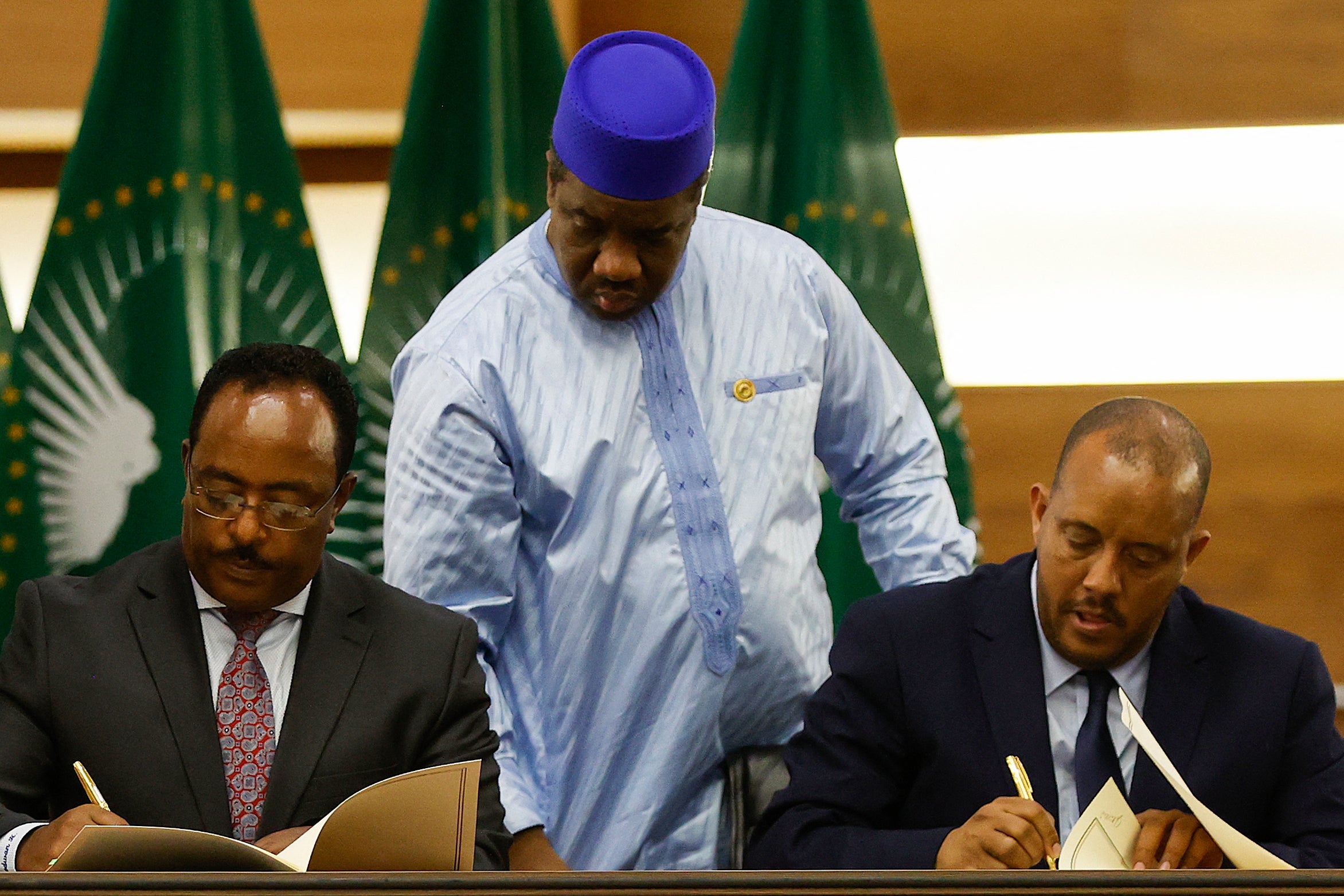 Redwan Hussein (L), Representative of the Ethiopian government, and Getachew Reda (R), Representative of the Tigray People's Liberation Front (TPLF), sign a peace agreement between the two parties