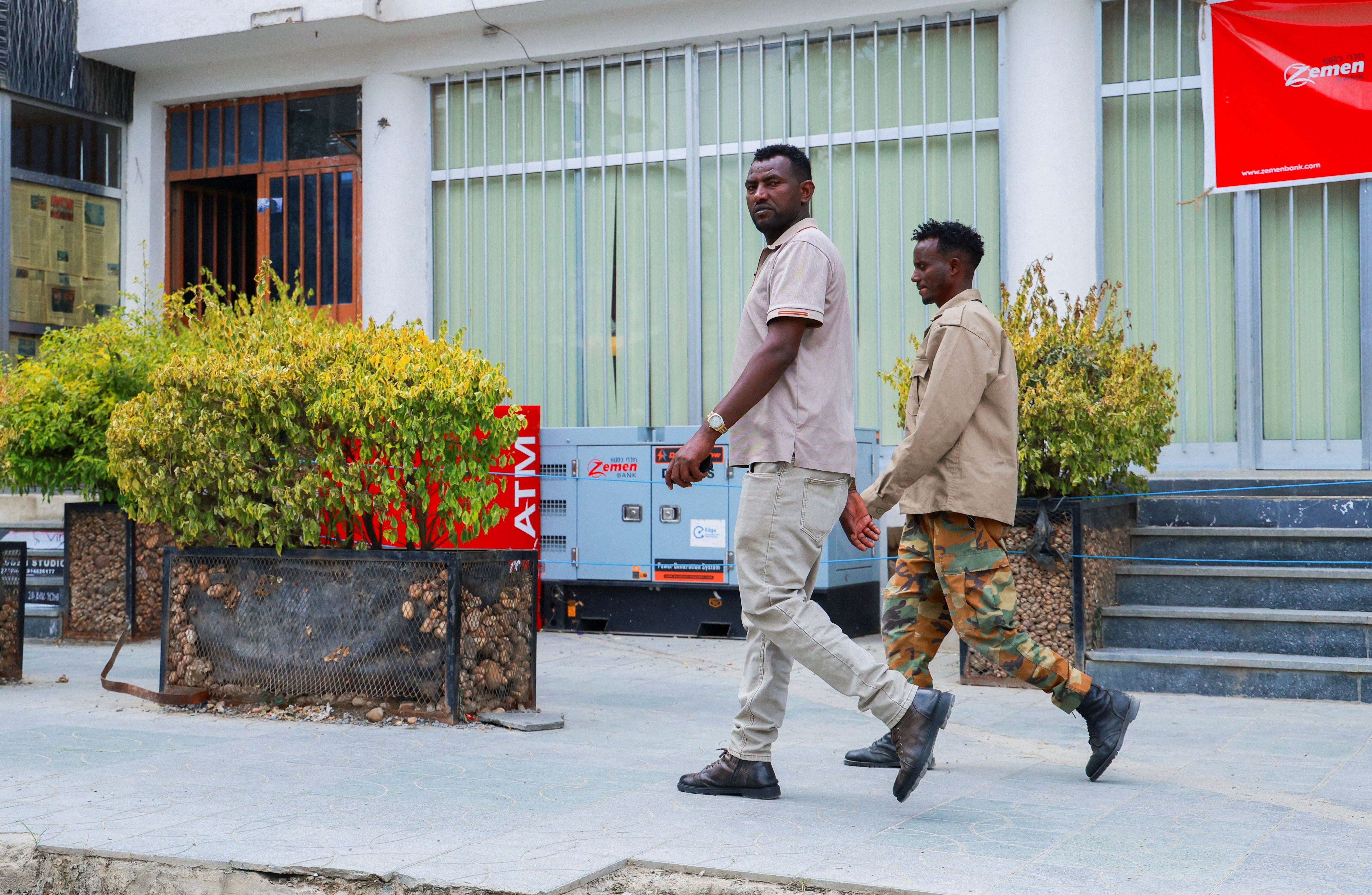 Members of Tigrayan forces patrol along a street