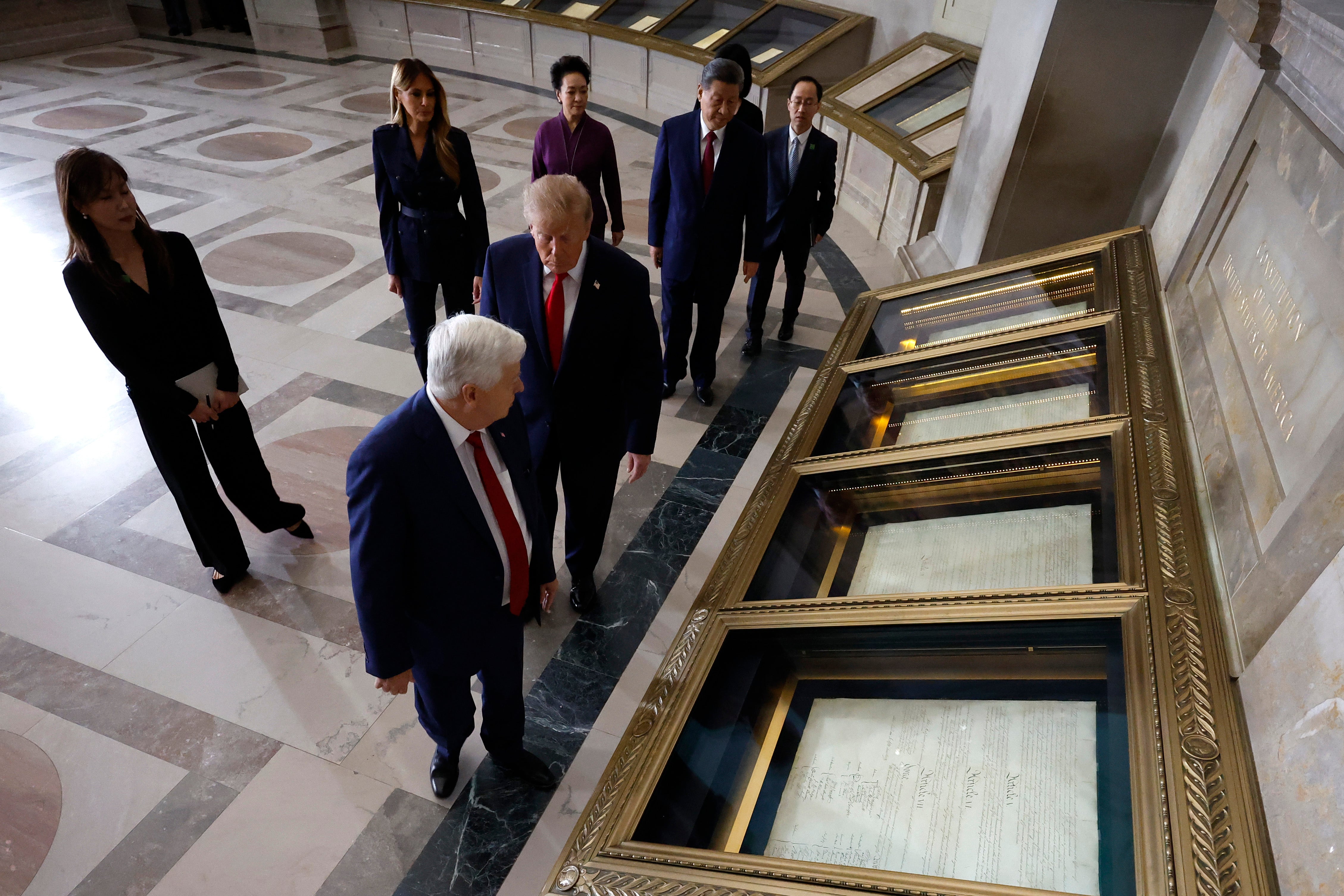 Archivist of the United States Bradford Wilson (L) leads U.S. President Donald Trump, President of China Xi Jinping, first lady of China Peng Liyuan and first lady Melania Trump on a tour of the National Archives